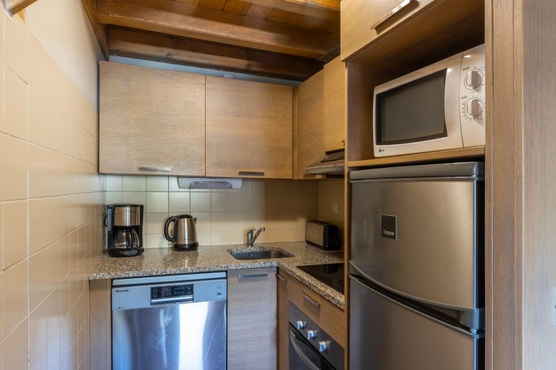 image Kitchen with wooden cabinets, modern appliances, and granite countertops — well-equipped for a group stay