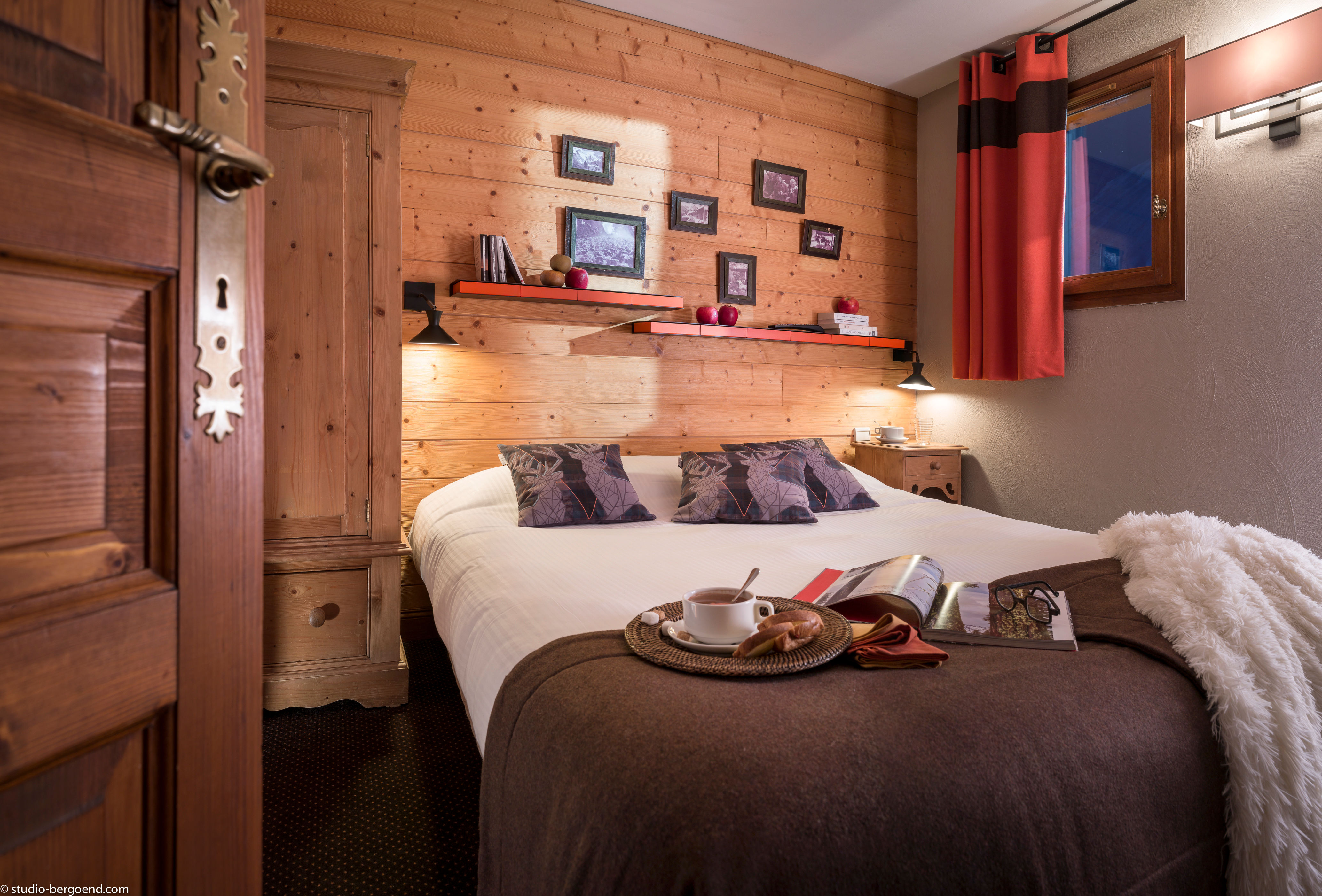 image Cozy double bedroom with soft lighting and alpine-style accents.