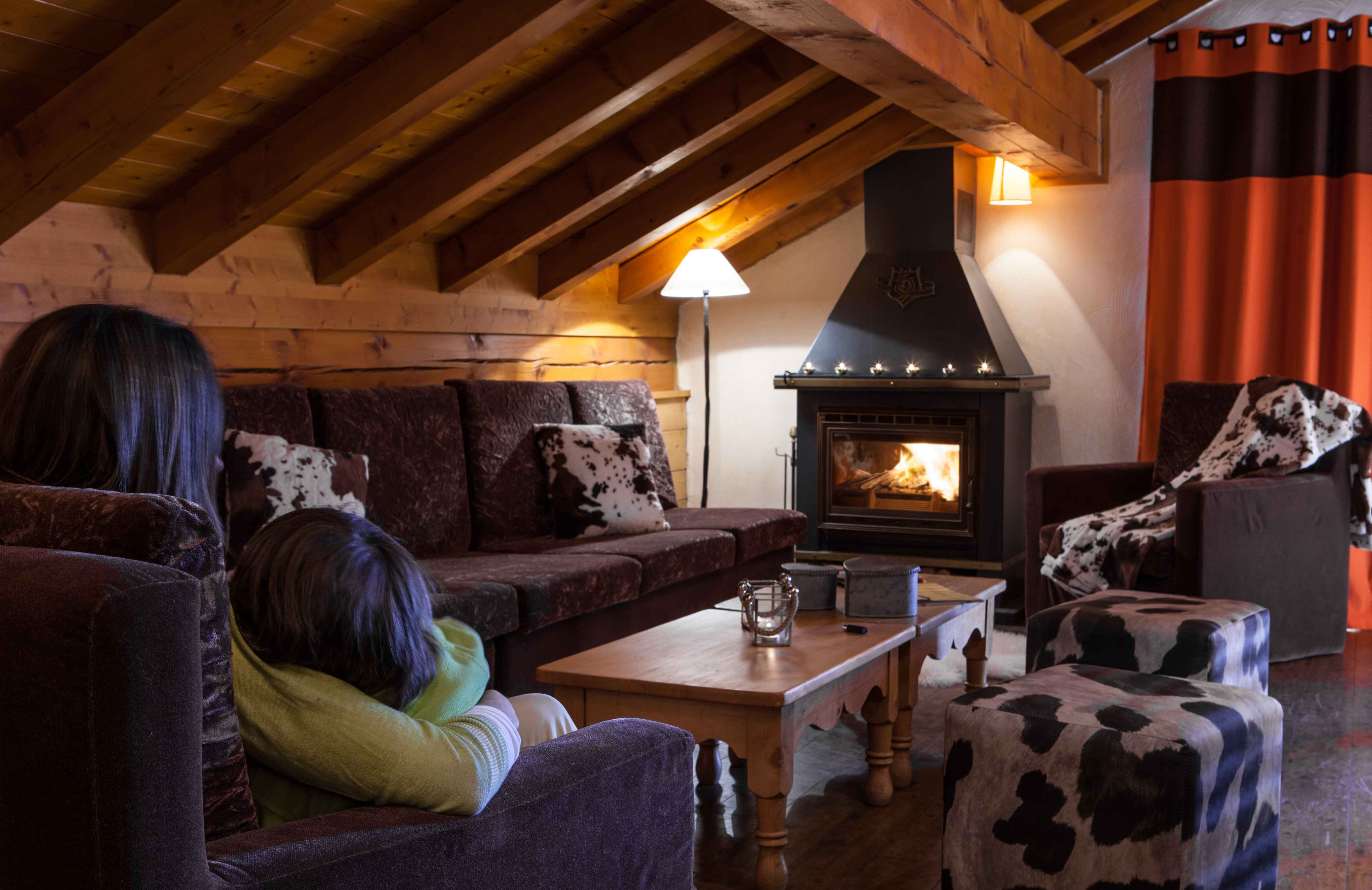 image Spacious living room with fireplace and alpine charm, perfect for gathering after a day on the pistes.