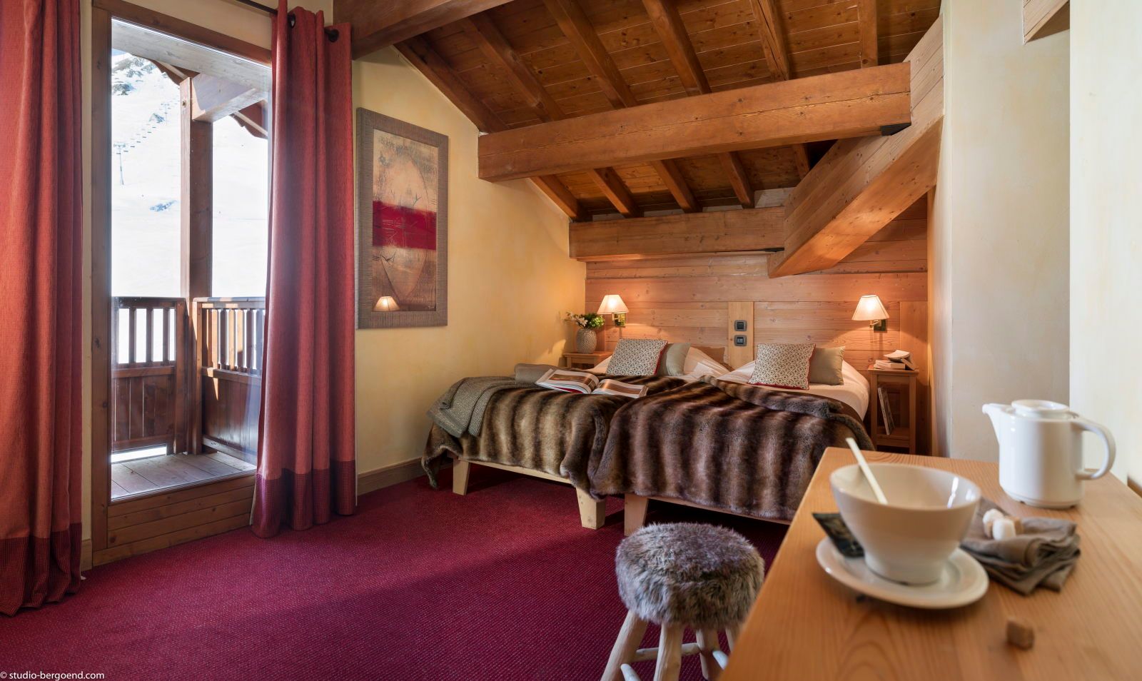 image Bedroom with balcony access, warm colouring, and cosy bedside lamps for a relaxing retreat