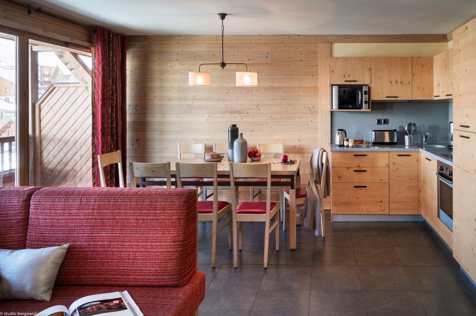 image Kitchen and dining area with wooden cabinets, a dining table, and modern appliances