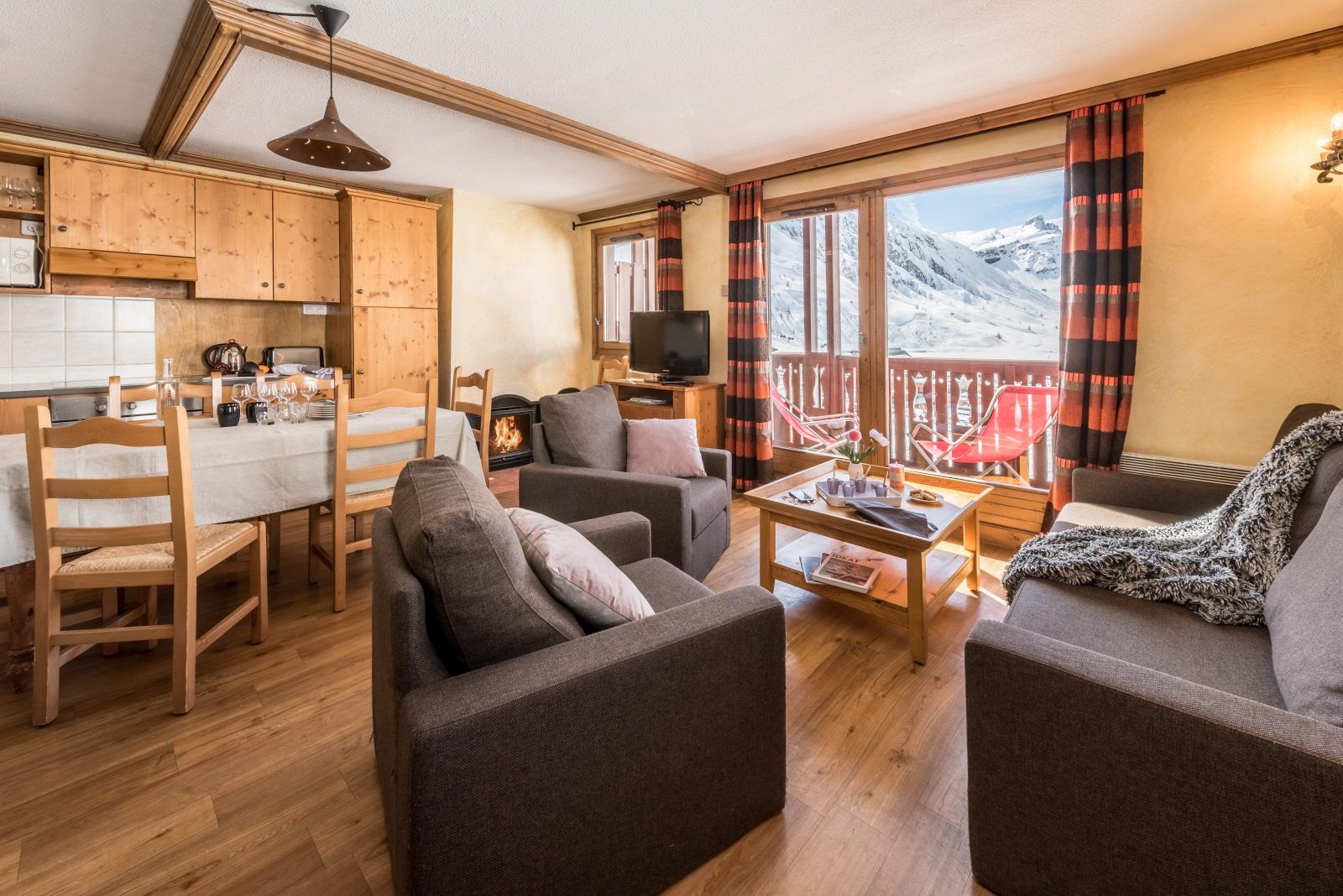 image Living area with a kitchen, dining table, and mountain views visible through the windows
