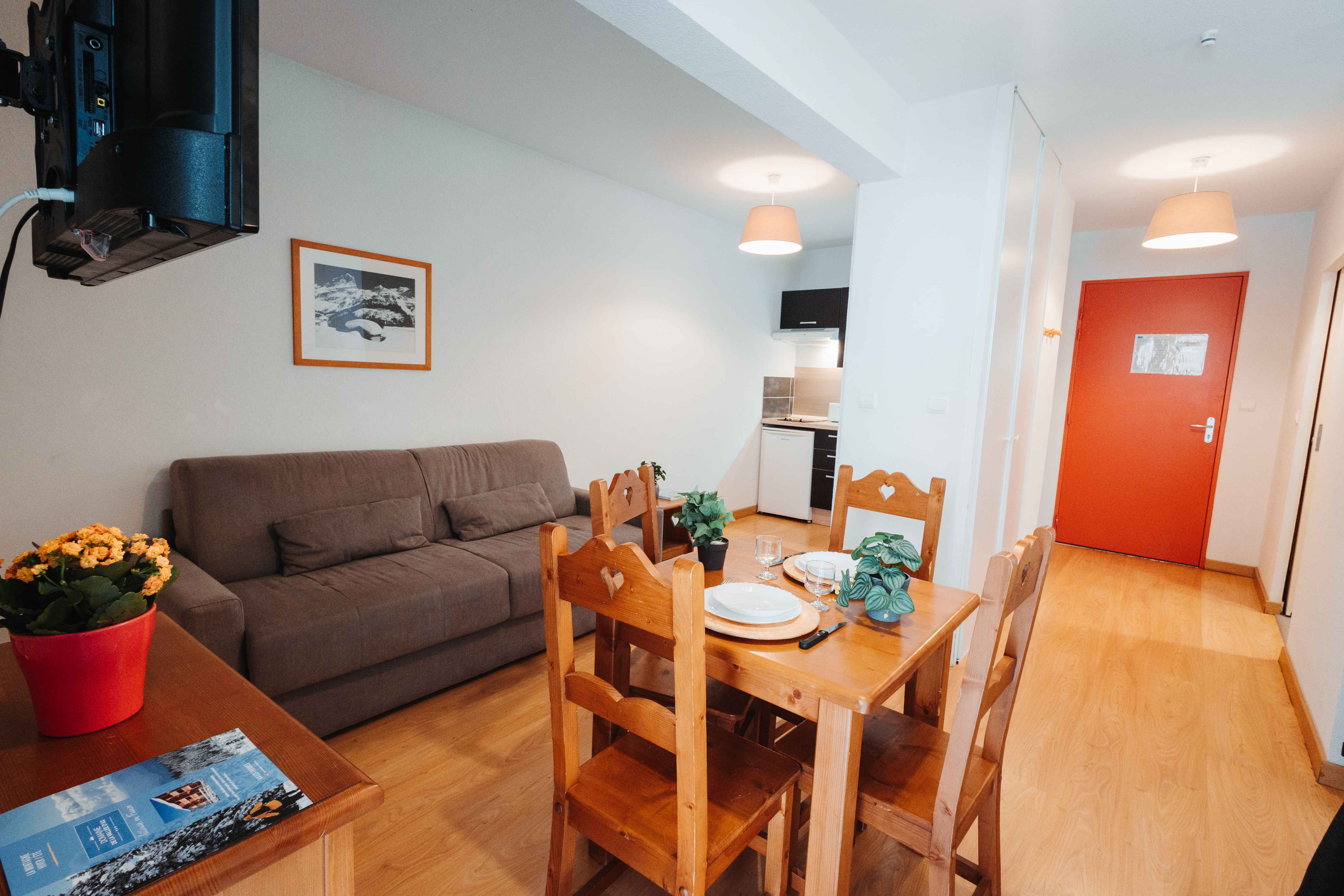 image Unwind in the cozy lounge area featuring flexible sleeping space and natural light.