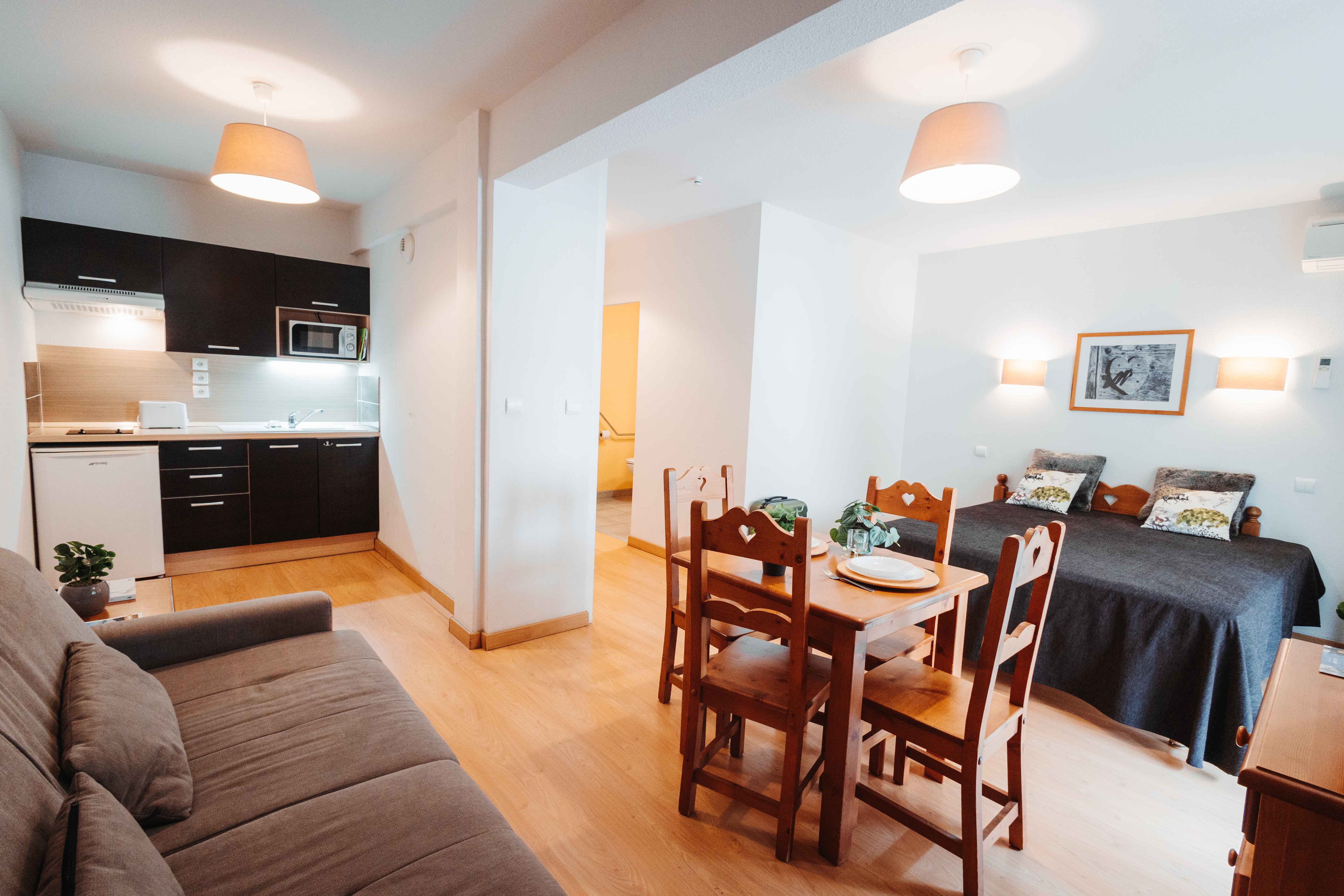 image Open layout blends dining, lounging, and cooking for a relaxed mountain escape.