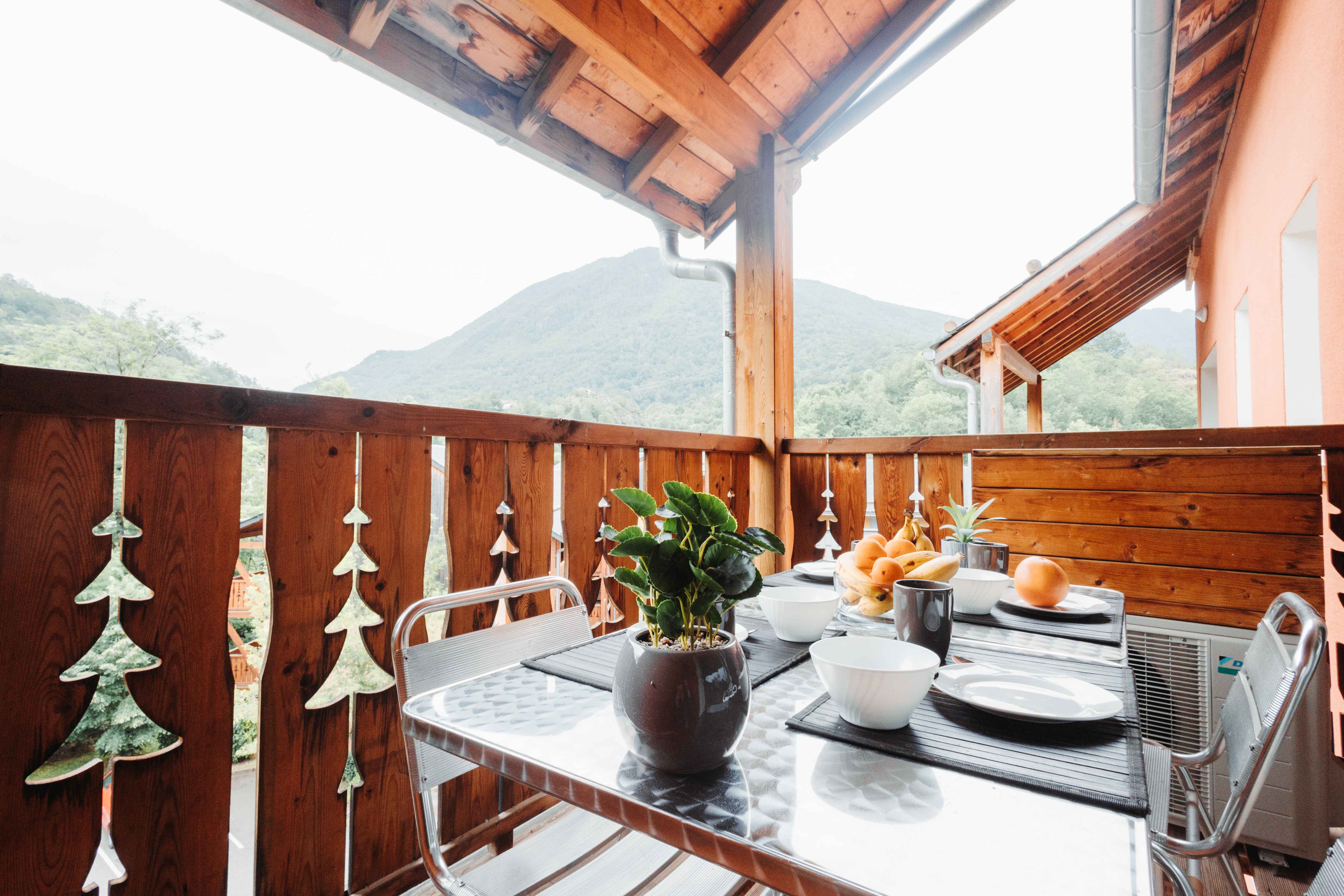 image Savor morning coffee or evening wine on the furnished balcony with serene alpine views.