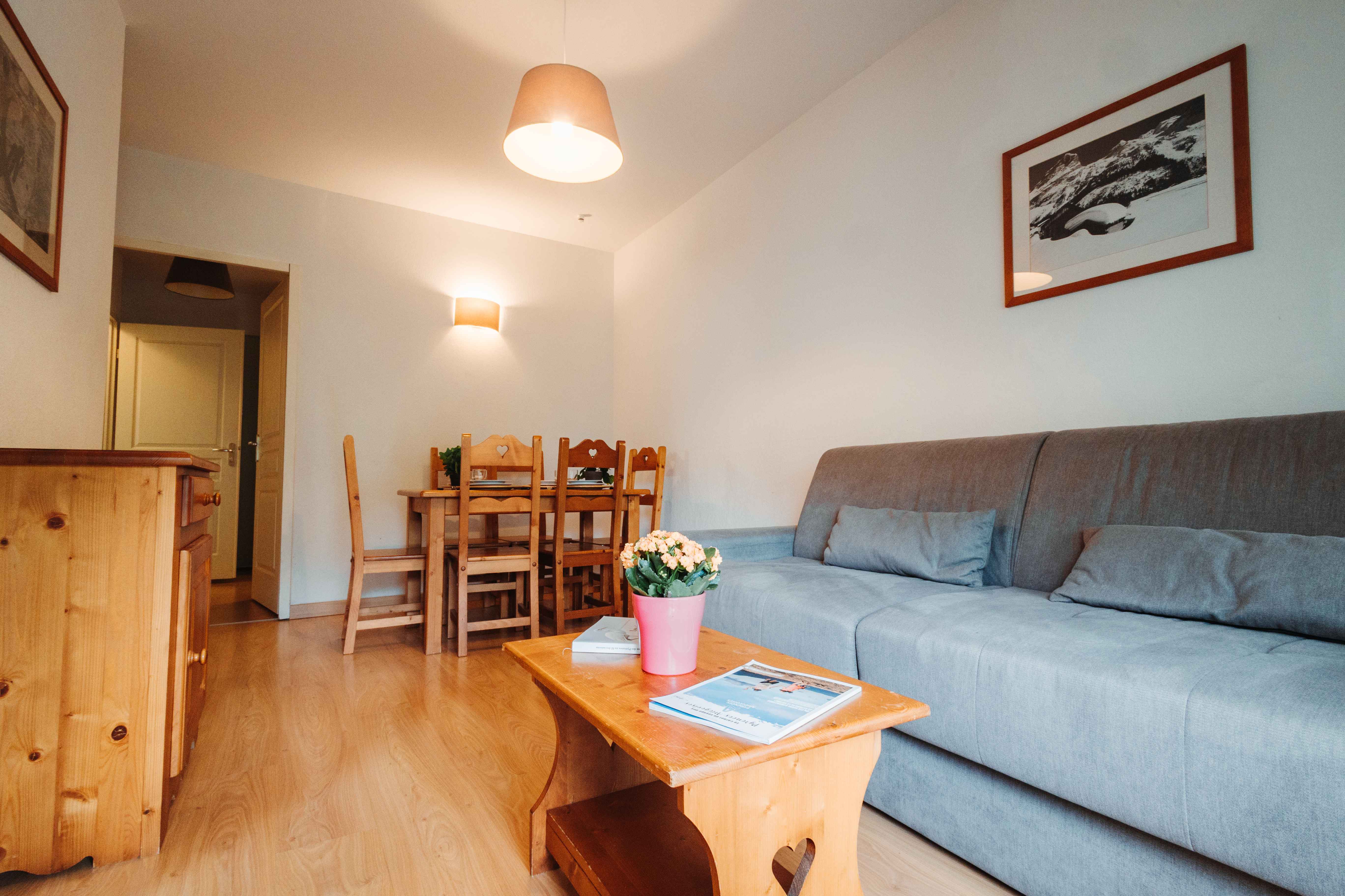 image Relax in the air-conditioned living room with a comfy sofa bed and charming alpine décor.