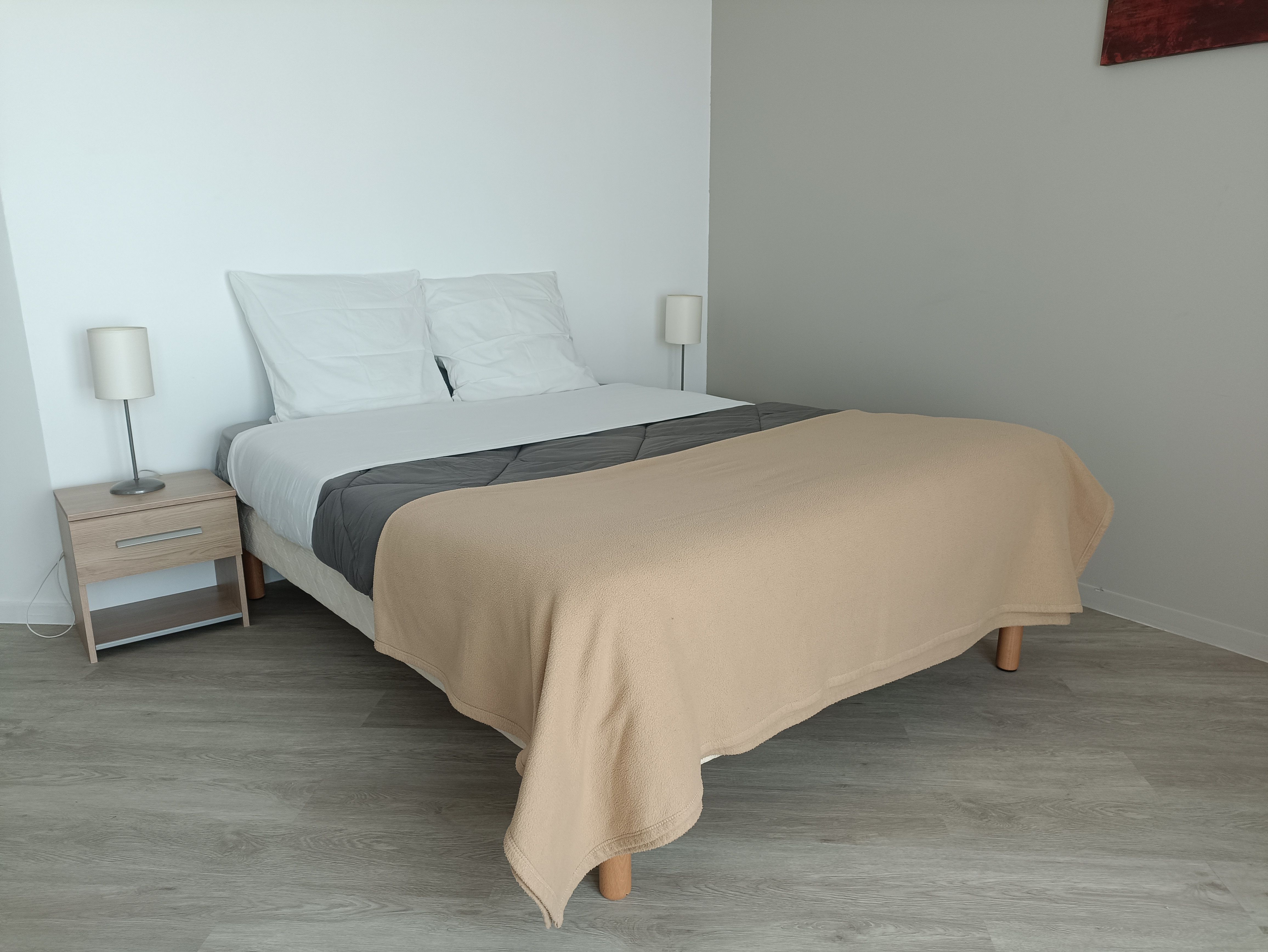 image A warm and inviting bedroom showcasing a comfortable bed, soft linens, and ambient lighting for a restful night's sleep.