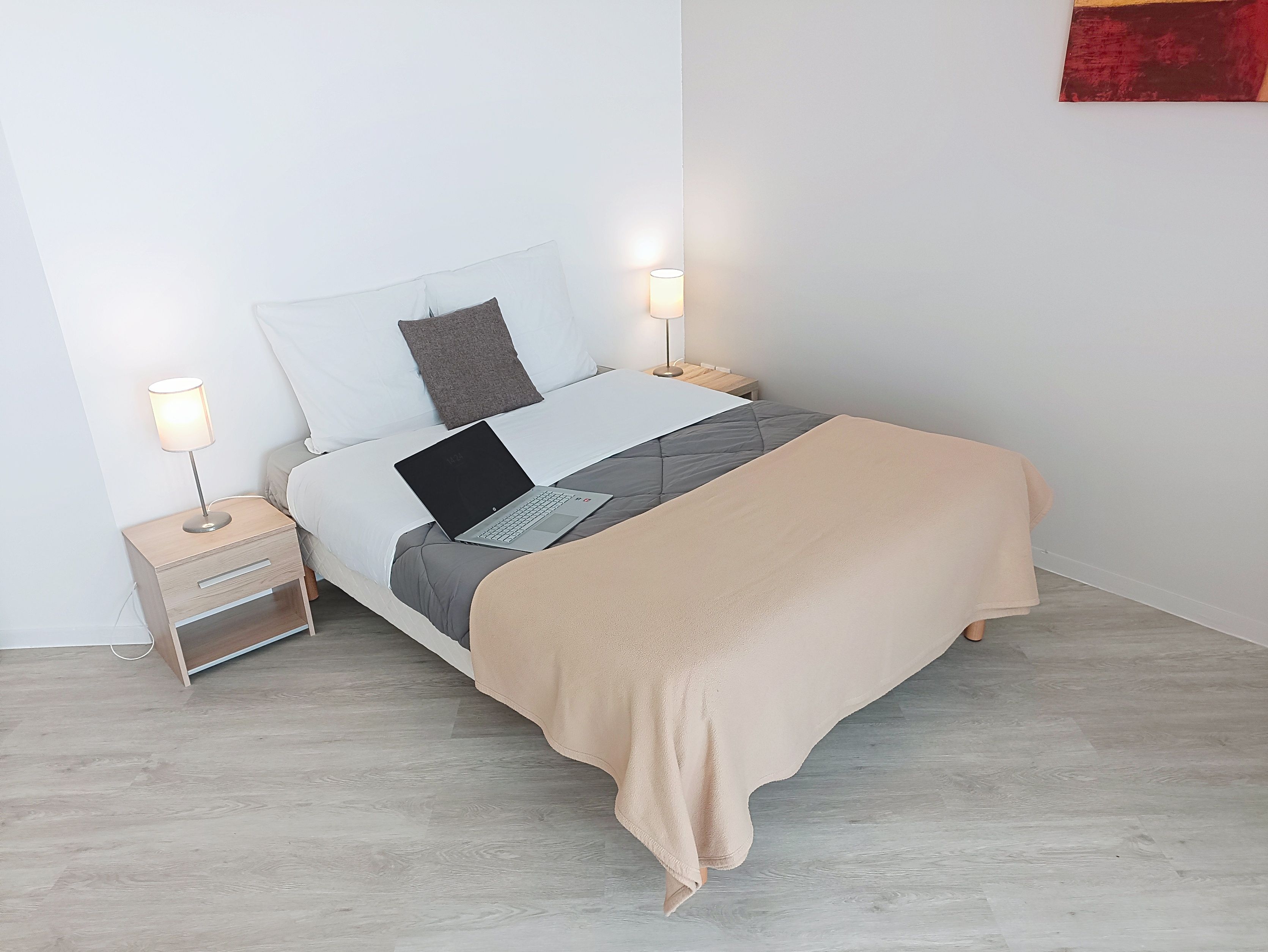 image Experience serenity in this cozy bedroom, furnished with a comfortable bed, soft lighting, and a workspace for your convenience.