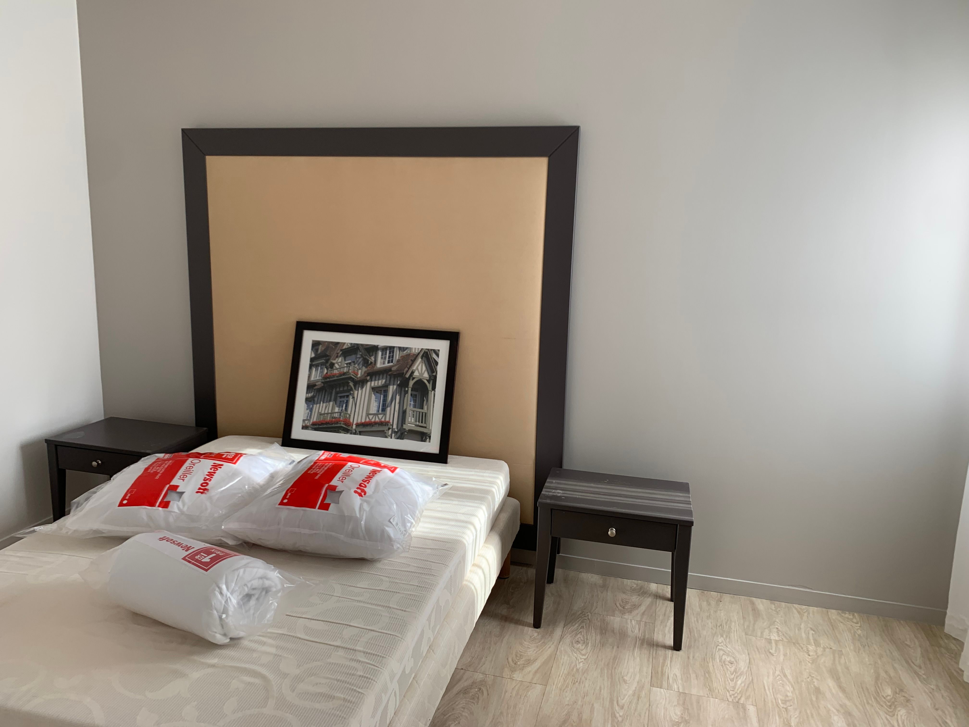 image Bedroom with double bed, padded headboard, and dark wood bedside tables.