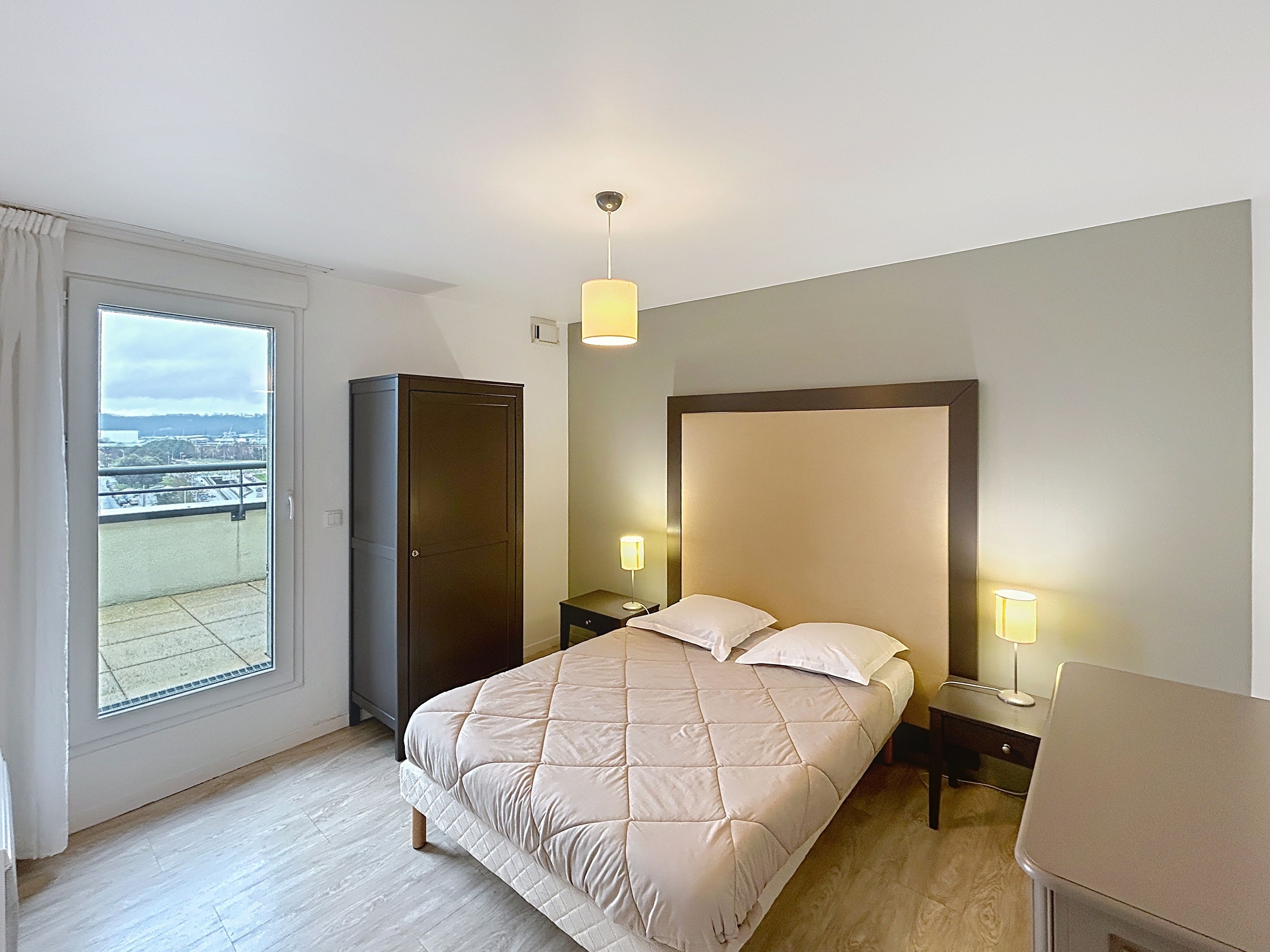 image Bedroom with bed, storage cabinet, bedside lamps, and window.
