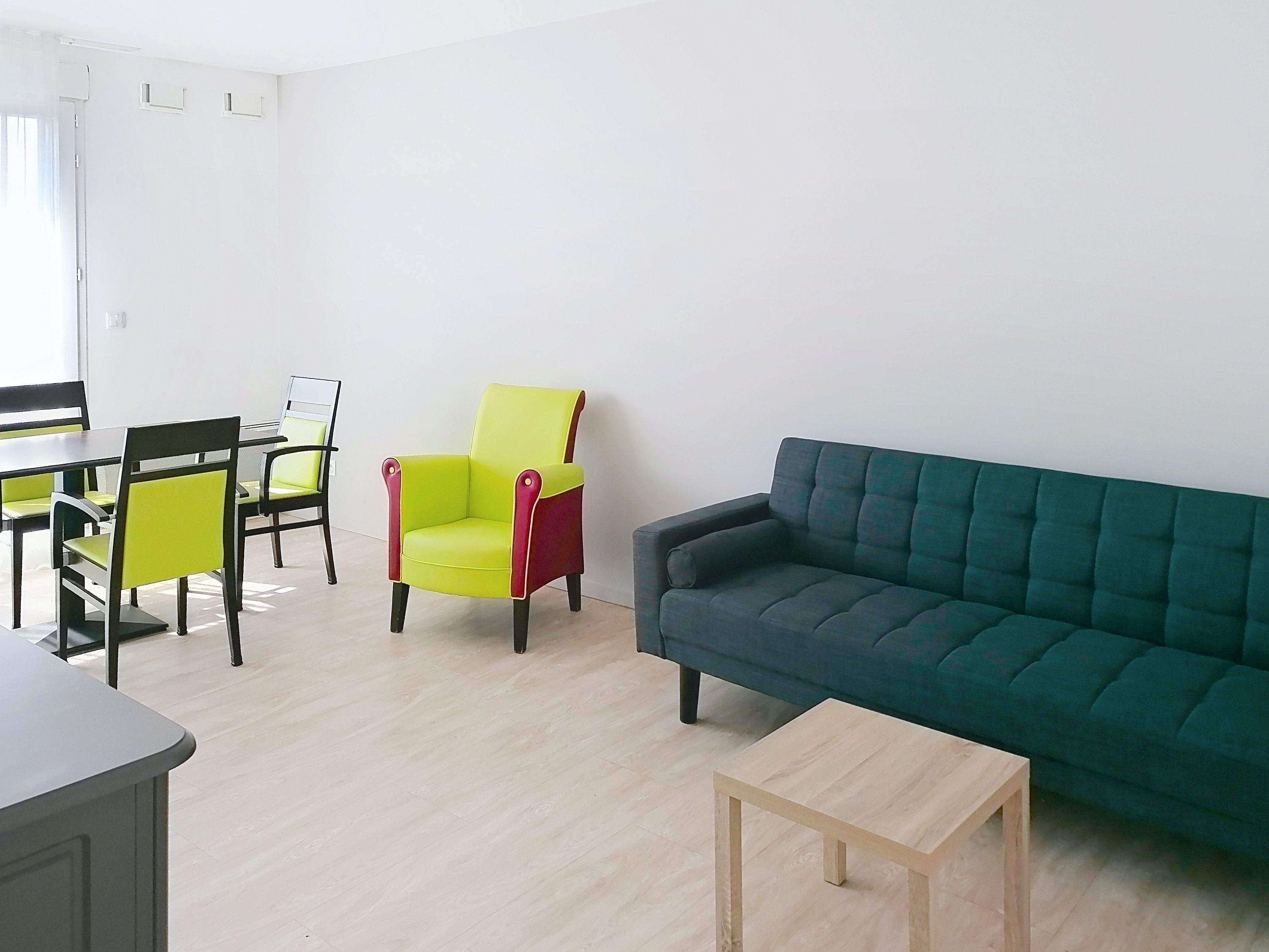 image Room with contrasting chairs, sofa, dining table, and light wood flooring.