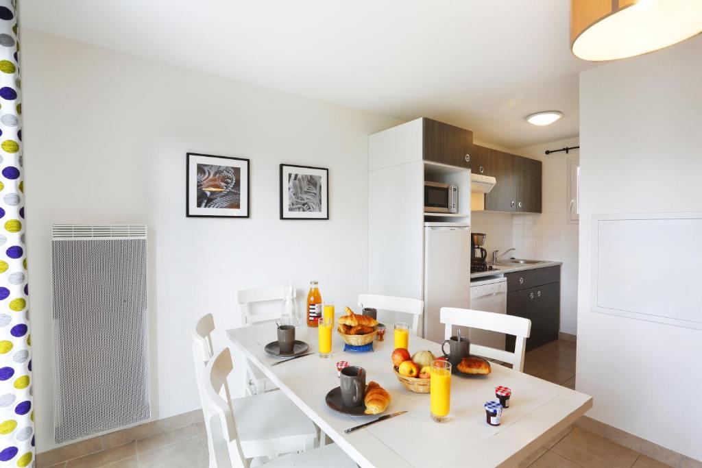 image Fully equipped kitchenette seamlessly integrated into the dining space, perfect for preparing delightful meals.