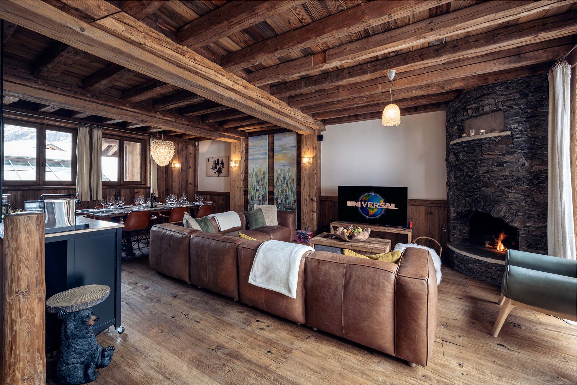 image Relax in the opulent living room equipped with plush seating, a stylish décor, and a large TV, perfect for cozy movie nights with loved ones.