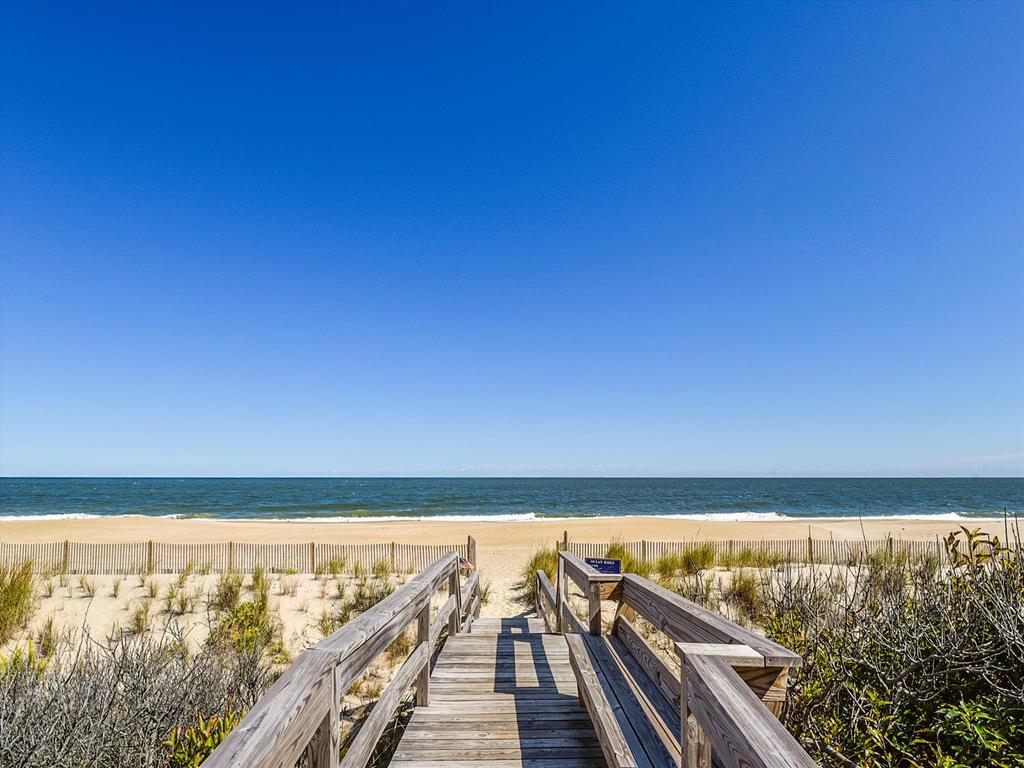 image Scenic boardwalk leading to the guarded private beach just steps from the house.