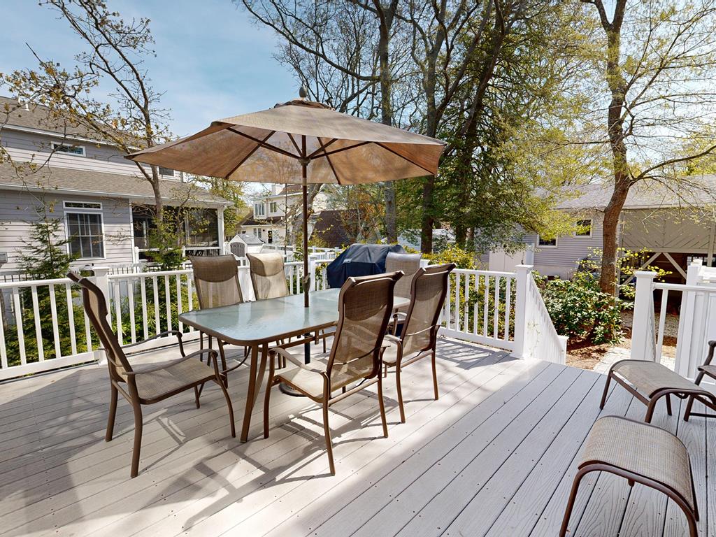 image Gather outdoors under the shade of an umbrella, with a grill nearby and laughter filling the air for memorable meals with friends.