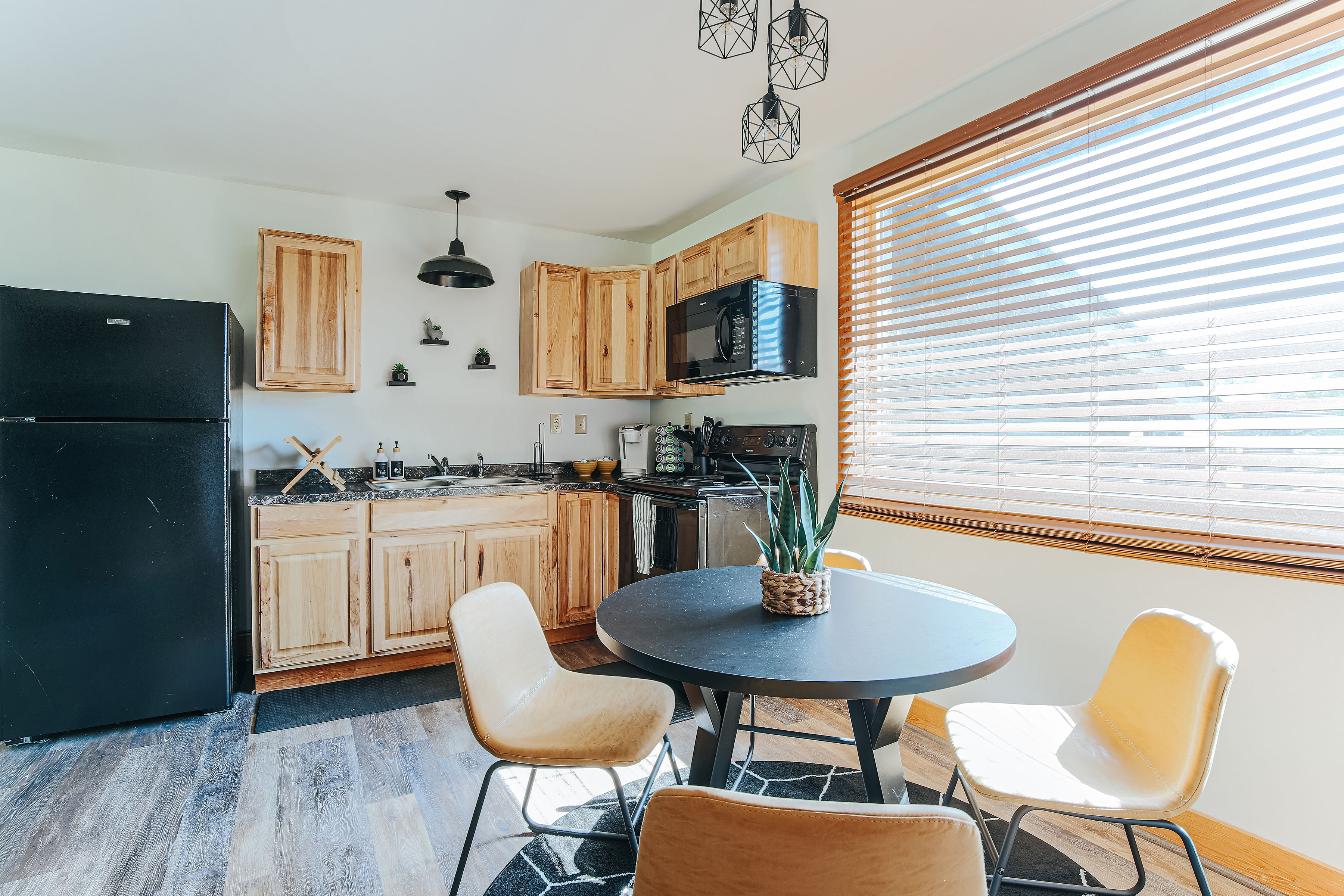 image Cozy kitchen with natural wood cabinets and sleek appliances.