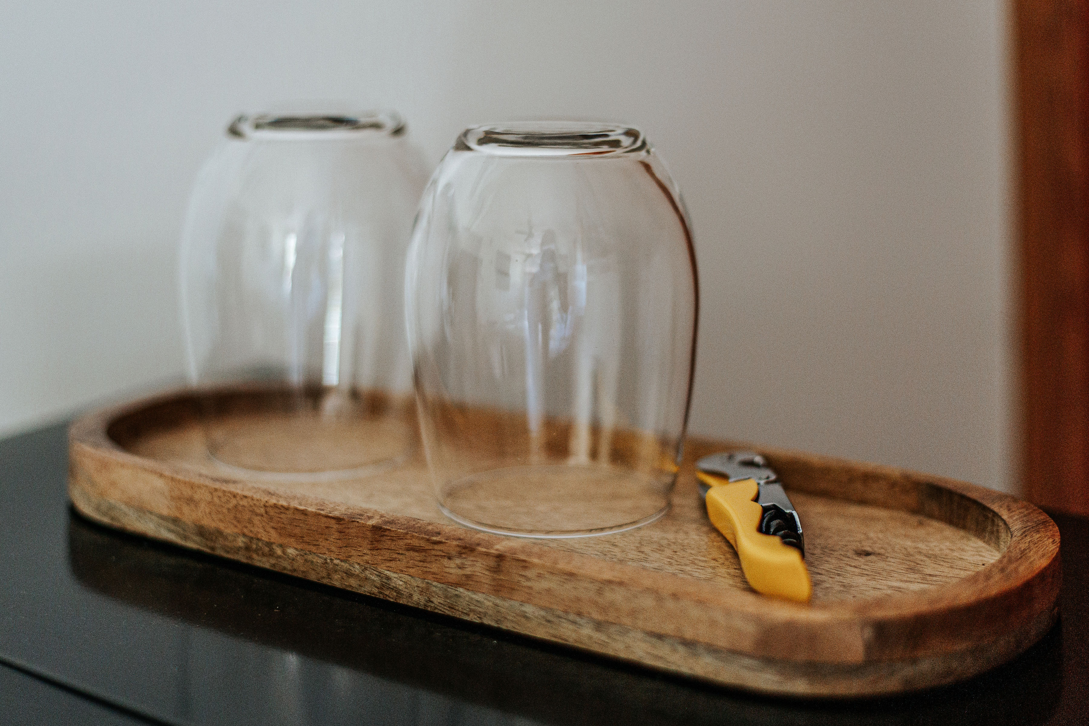 image Elegant glassware on a wooden tray adds charm.