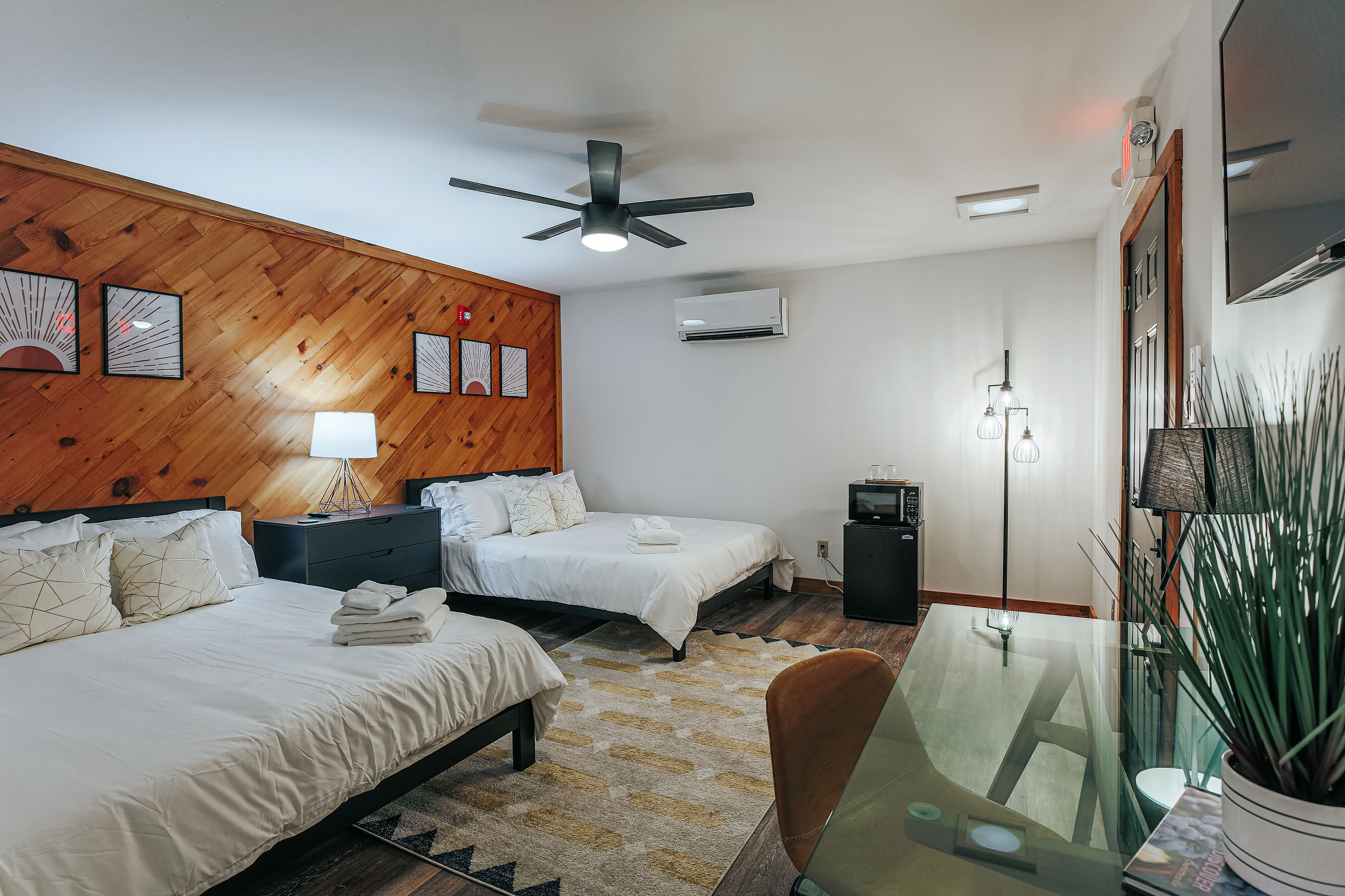 image Charming suite with two queen beds, desk, and rustic wood accents.
