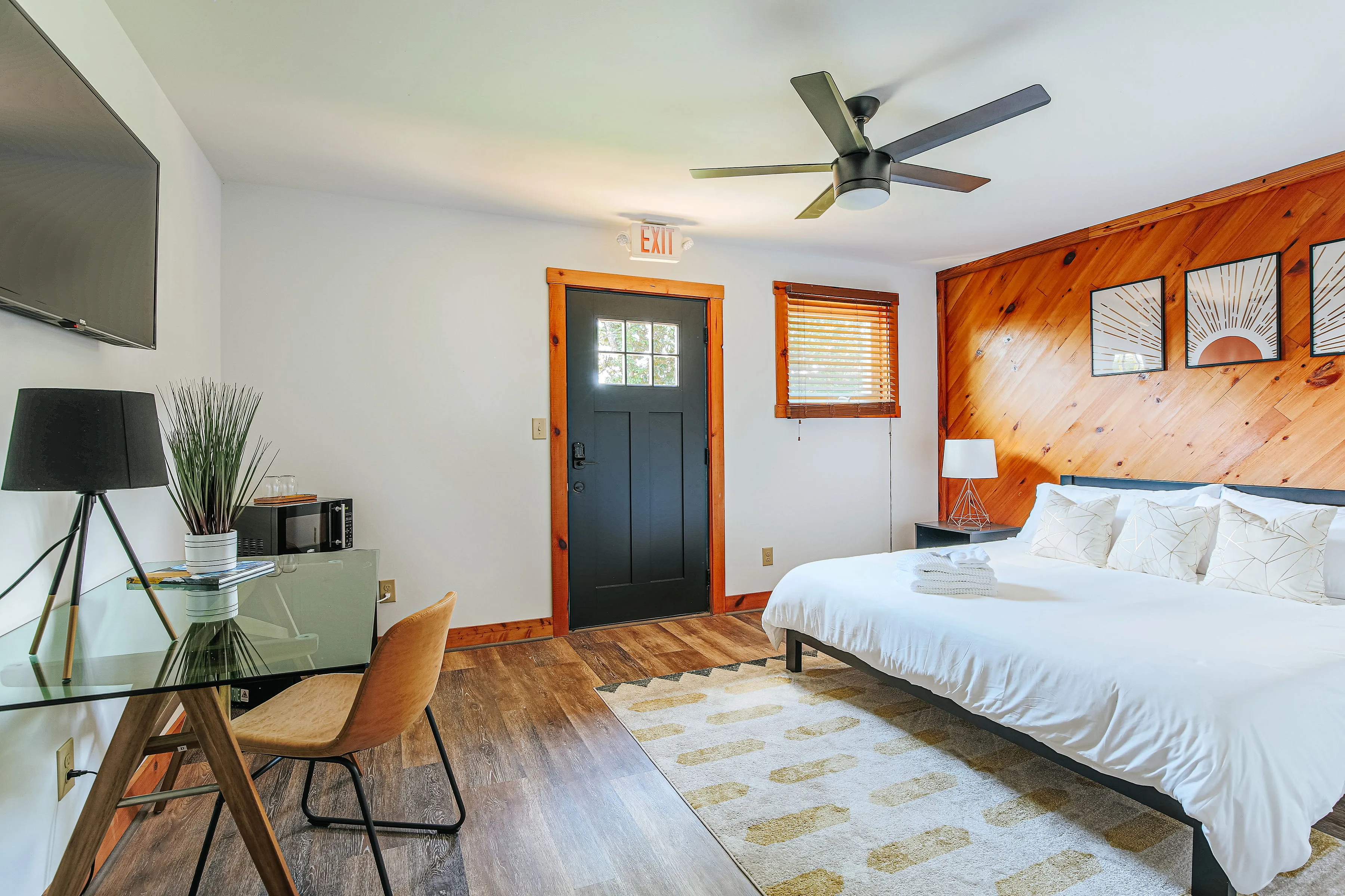 image Spacious king suite with cozy bed and modern desk.