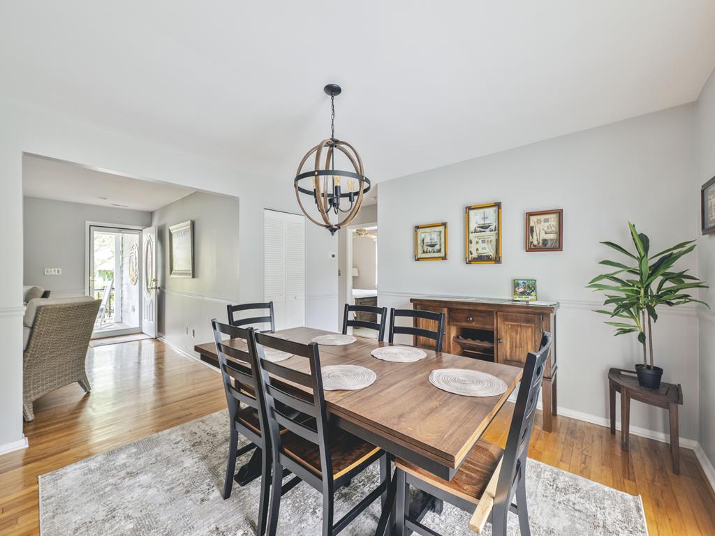 image The beautifully arranged dining area invites comfort and style, featuring tasteful decor and easy access to the backyard.