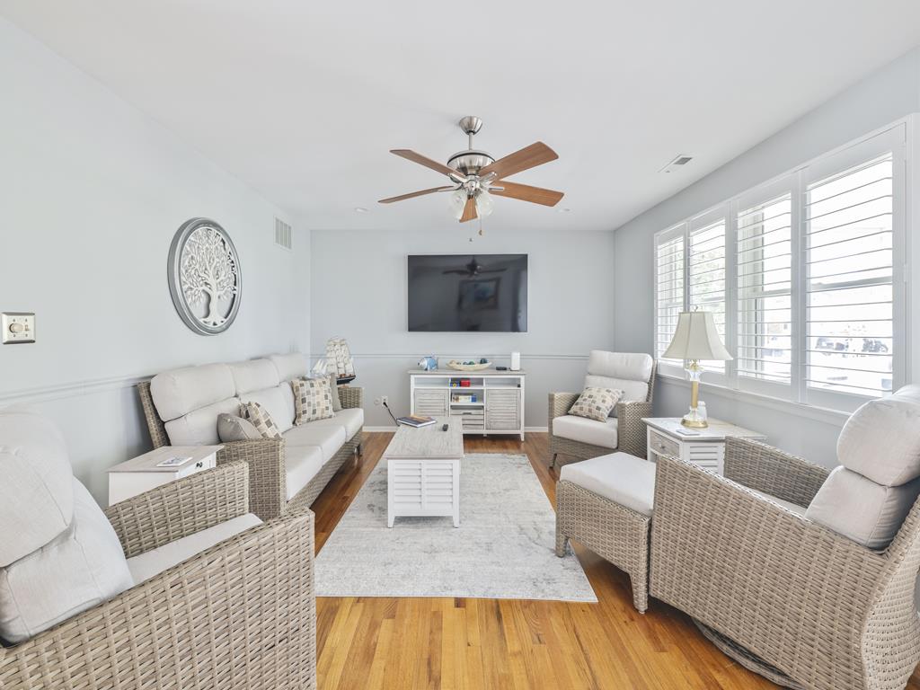 image This bright and airy living space features modern decor and large windows that invite natural light, creating a welcoming atmosphere for relaxation and entertainment.