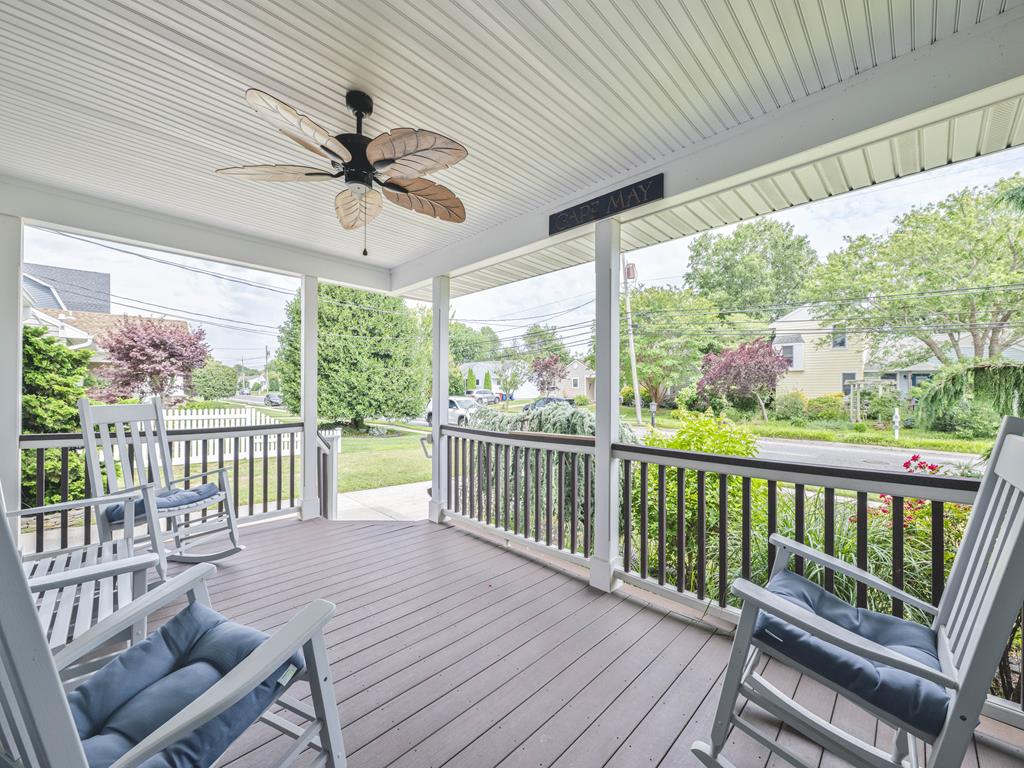 image Soak in the tranquil surroundings from this spacious porch, adorned with stylish seating and charming decor, ideal for enjoying the sun or evening relaxation.