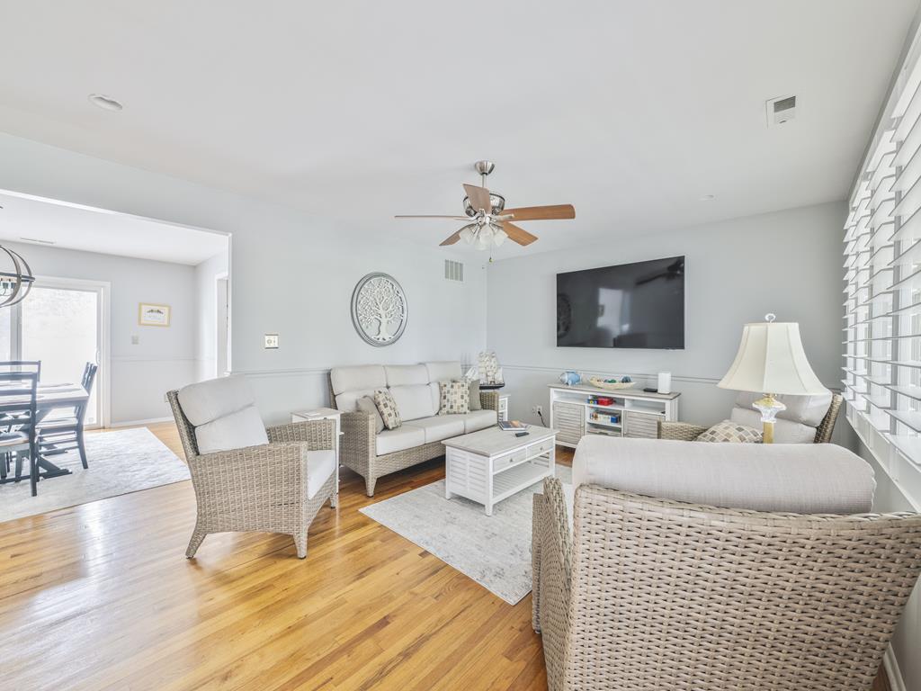 image Experience comfort in the living area, complete with cozy furnishings, a flat-screen TV, and warm wood flooring, perfect for family gatherings and quality time.