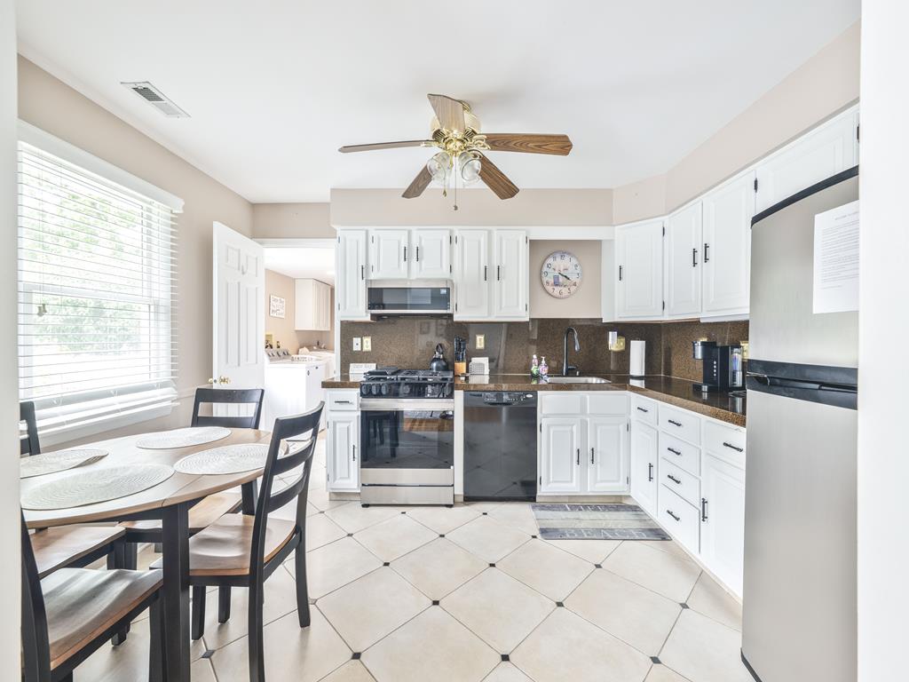 image The well-equipped kitchen boasts modern appliances, ample storage, and a breakfast nook perfect for morning coffee.