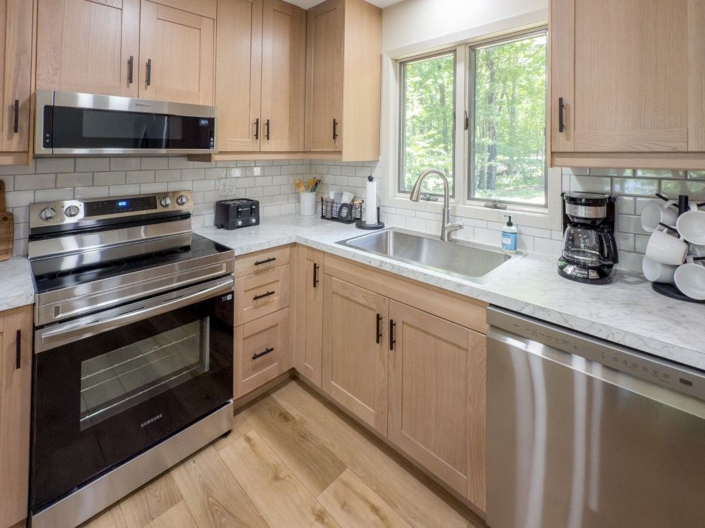 image Fully stocked kitchen with stainless steel appliances and bright windows, making meal prep easy after a day outdoors.