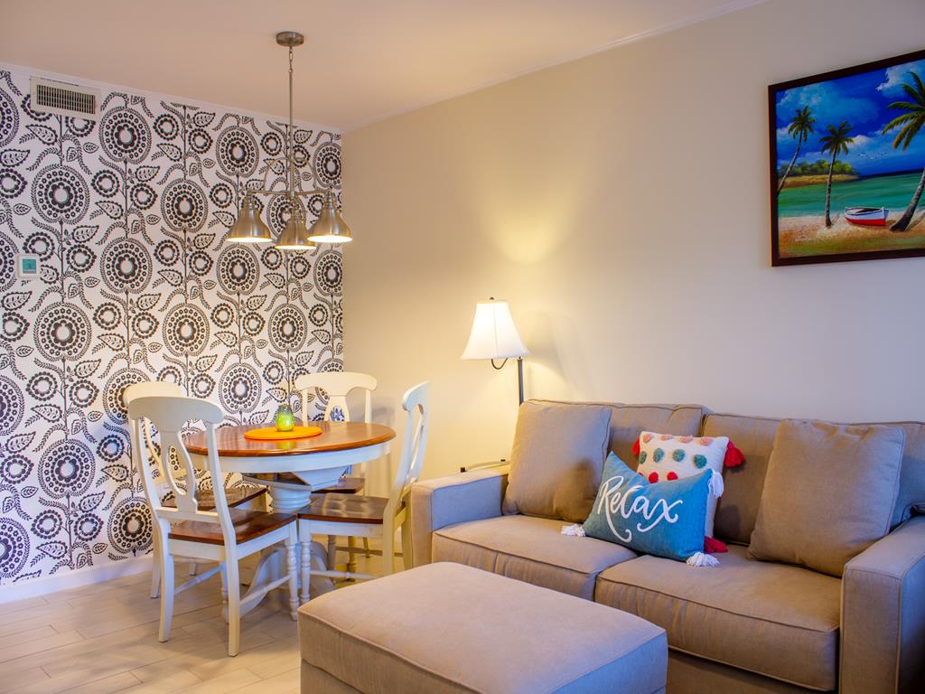 image Cozy dining and living area in this 1-bedroom condo, perfect for meals or planning adventures just steps from Cape May’s beach.