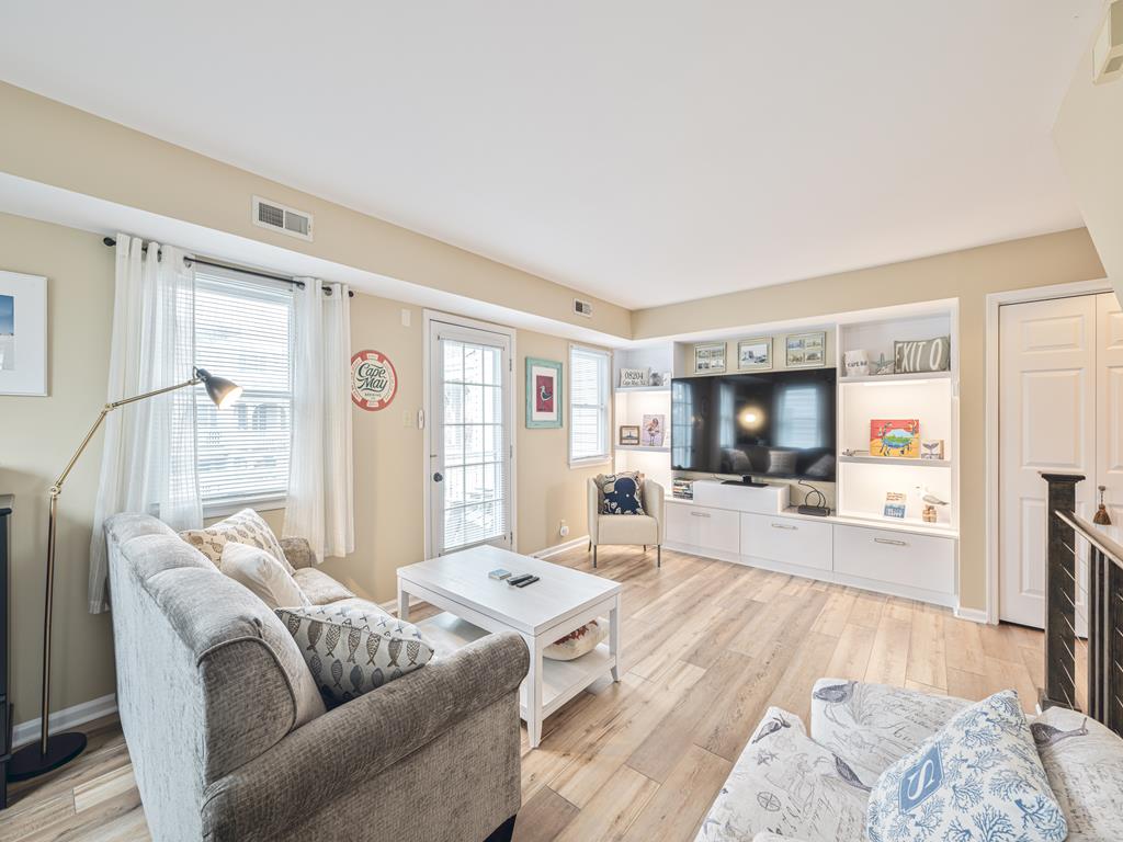 image Relax and unwind with smart TV entertainment and plush seating in this comfortable living area.
