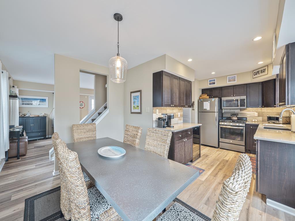 image Modern open kitchen with stainless steel appliances and island seating for casual dining.