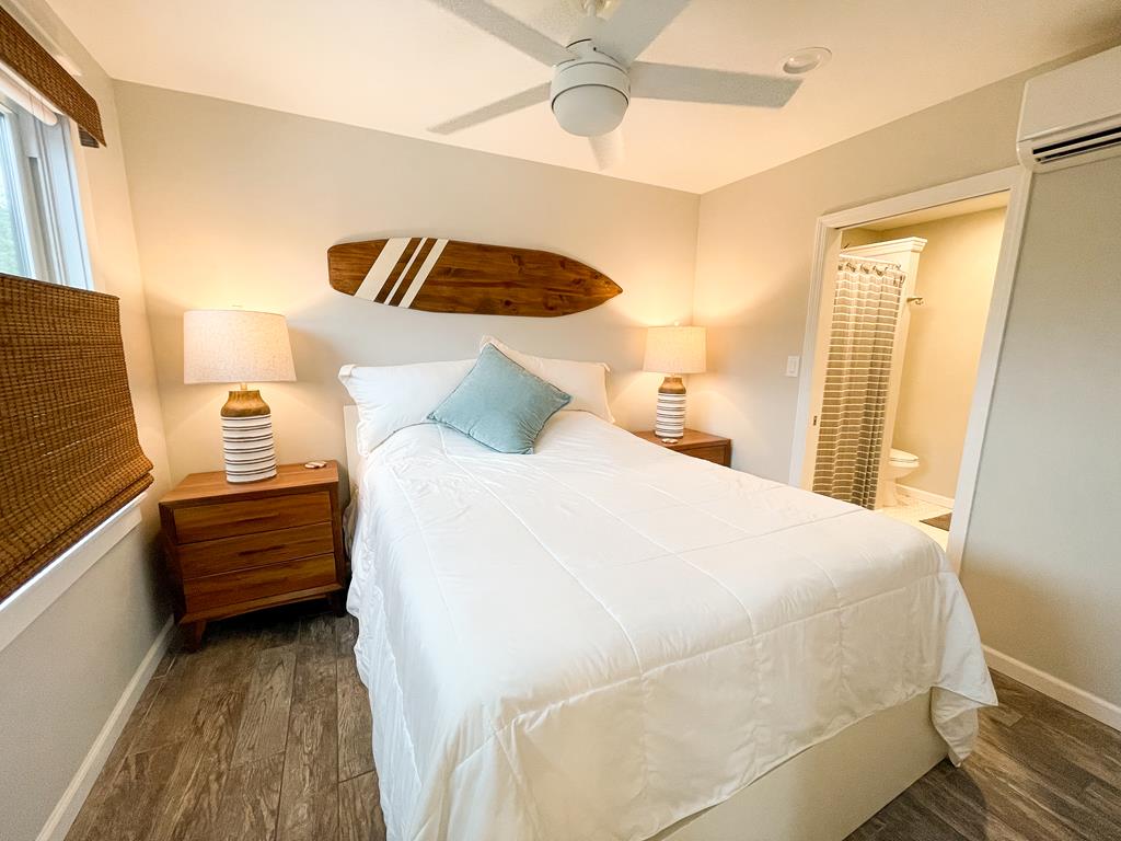 image Serene primary bedroom with a Double Bed, ceiling fan, and natural light—perfect for a restful night.