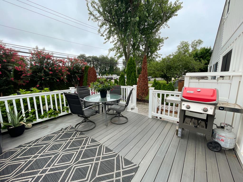 image Grill and dine outdoors on the private deck surrounded by blooming crepe myrtles.