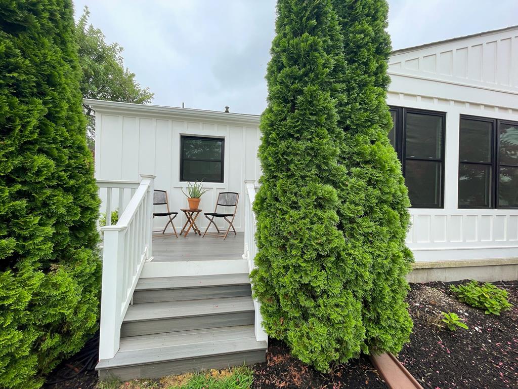 image Private outdoor deck with seating—perfect for morning coffee or al fresco dining among lush greenery.