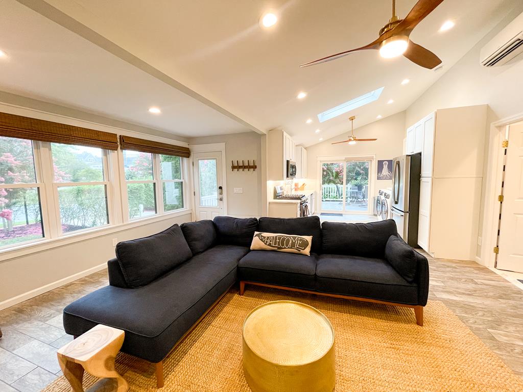 image Bright and inviting family room with large windows and comfortable seating for movie nights or game time.