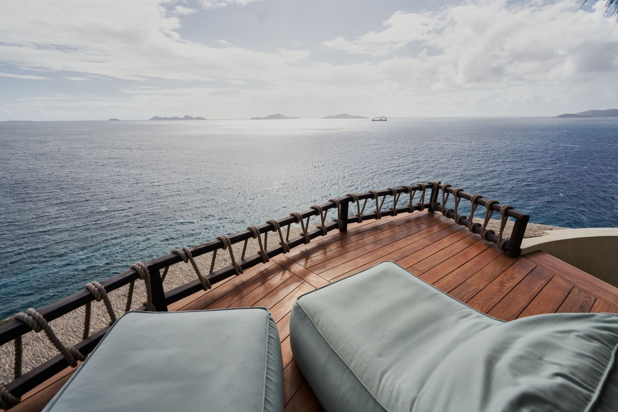 image Unwind on the private stargazing deck, where comfortable loungers offer breathtaking 360° views of the ocean and nearby islands.