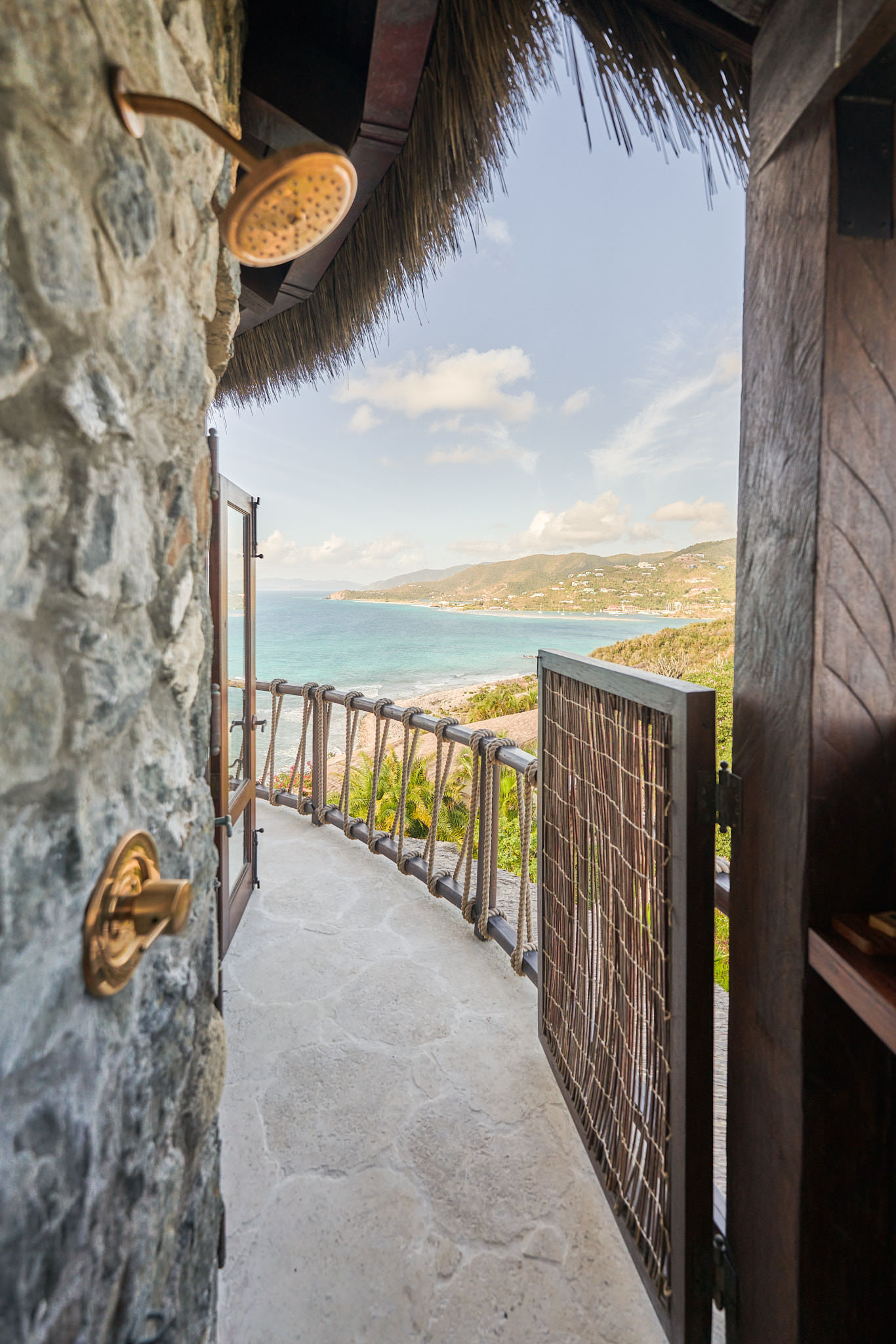 image Step onto the outdoor shower with a view, surrounded by natural stone and offering panoramic vistas of the lush landscape and sparkling waters.