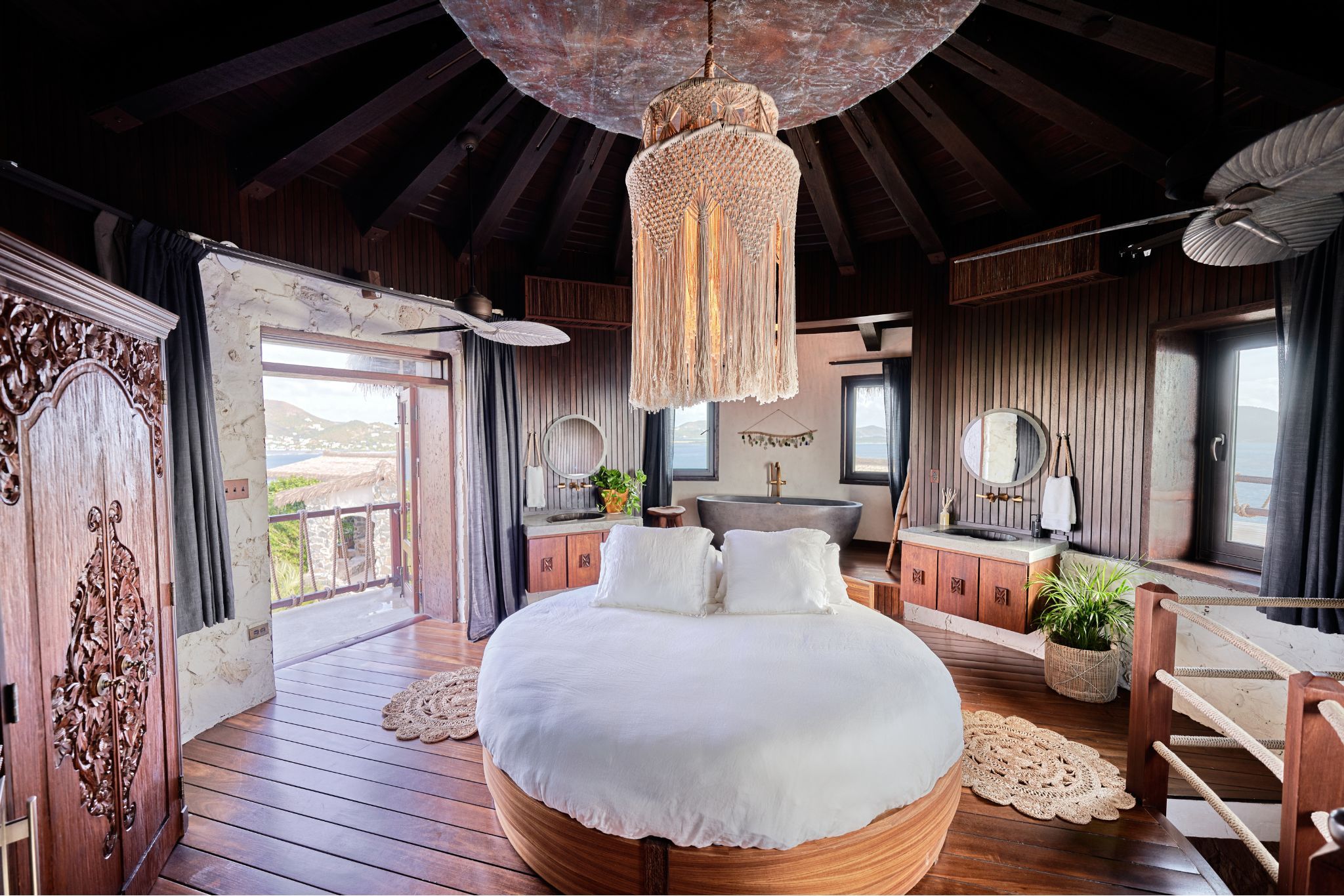 image The exquisite round king bed is complemented by chic decor and expansive views, creating a serene haven within the luxury suite.