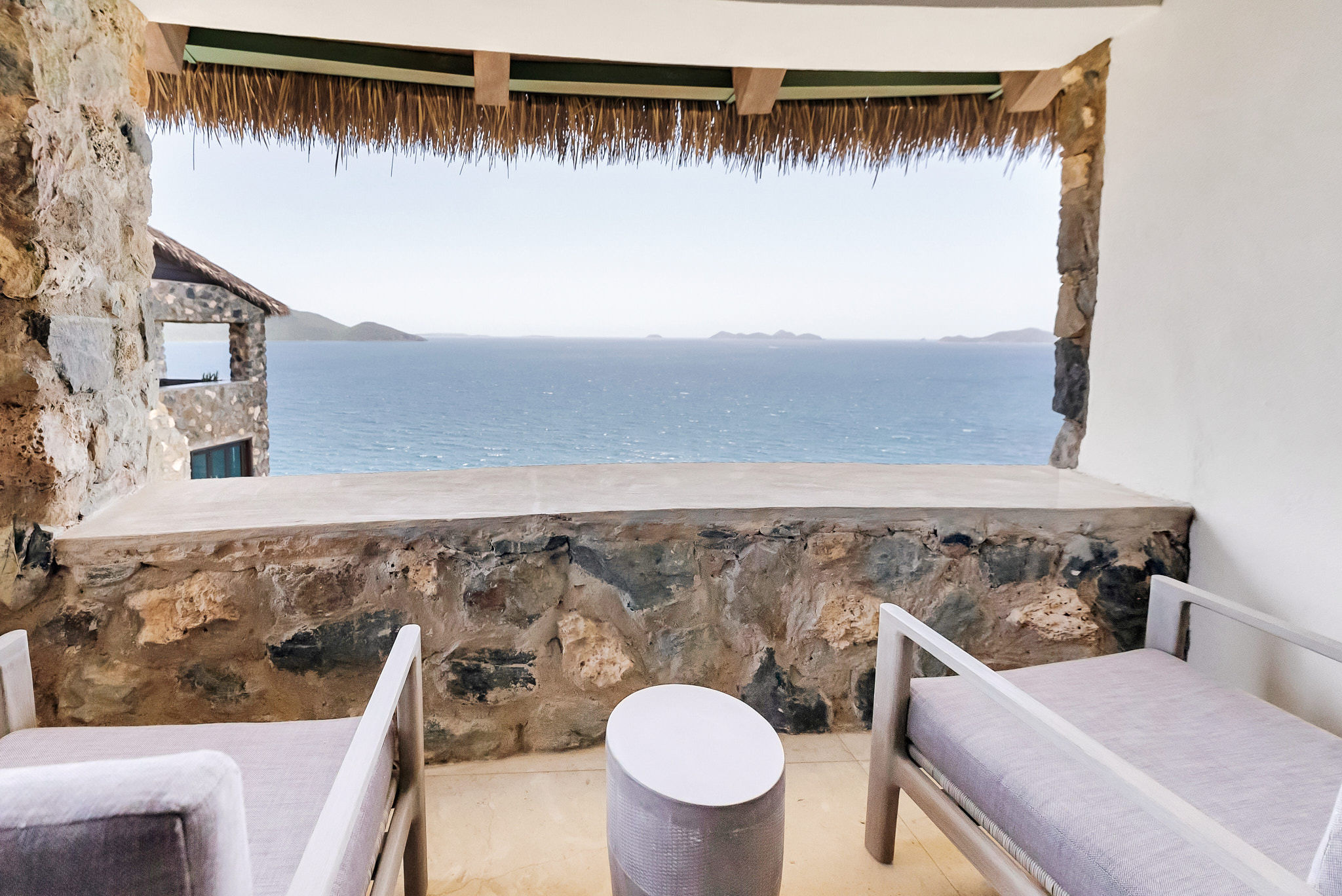 image Relax with panoramic views from this charming stone-built terrace, complete with cozy seating.
