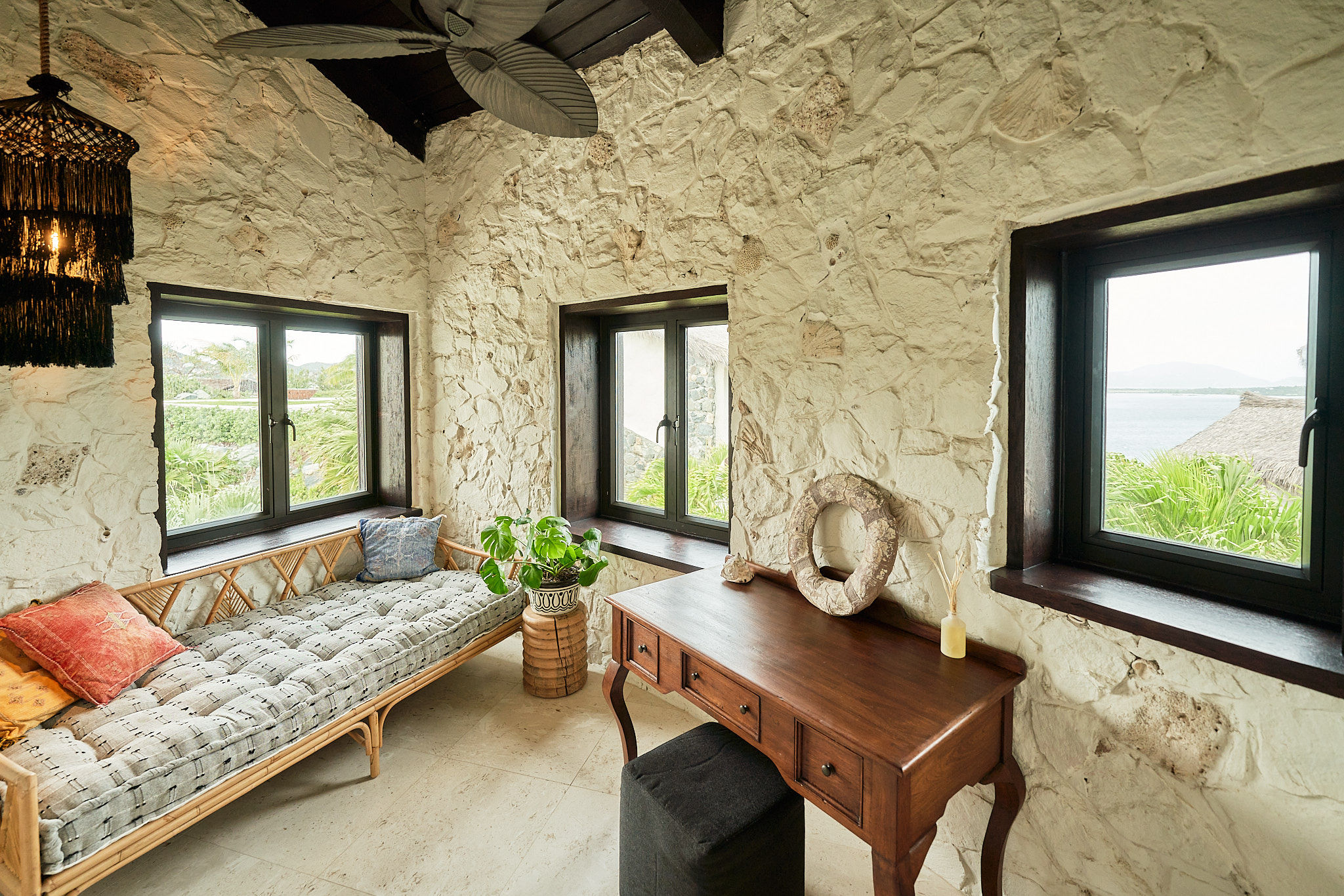 image A cozy lounge area with textured stone walls and natural light—perfect for reading or relaxing.