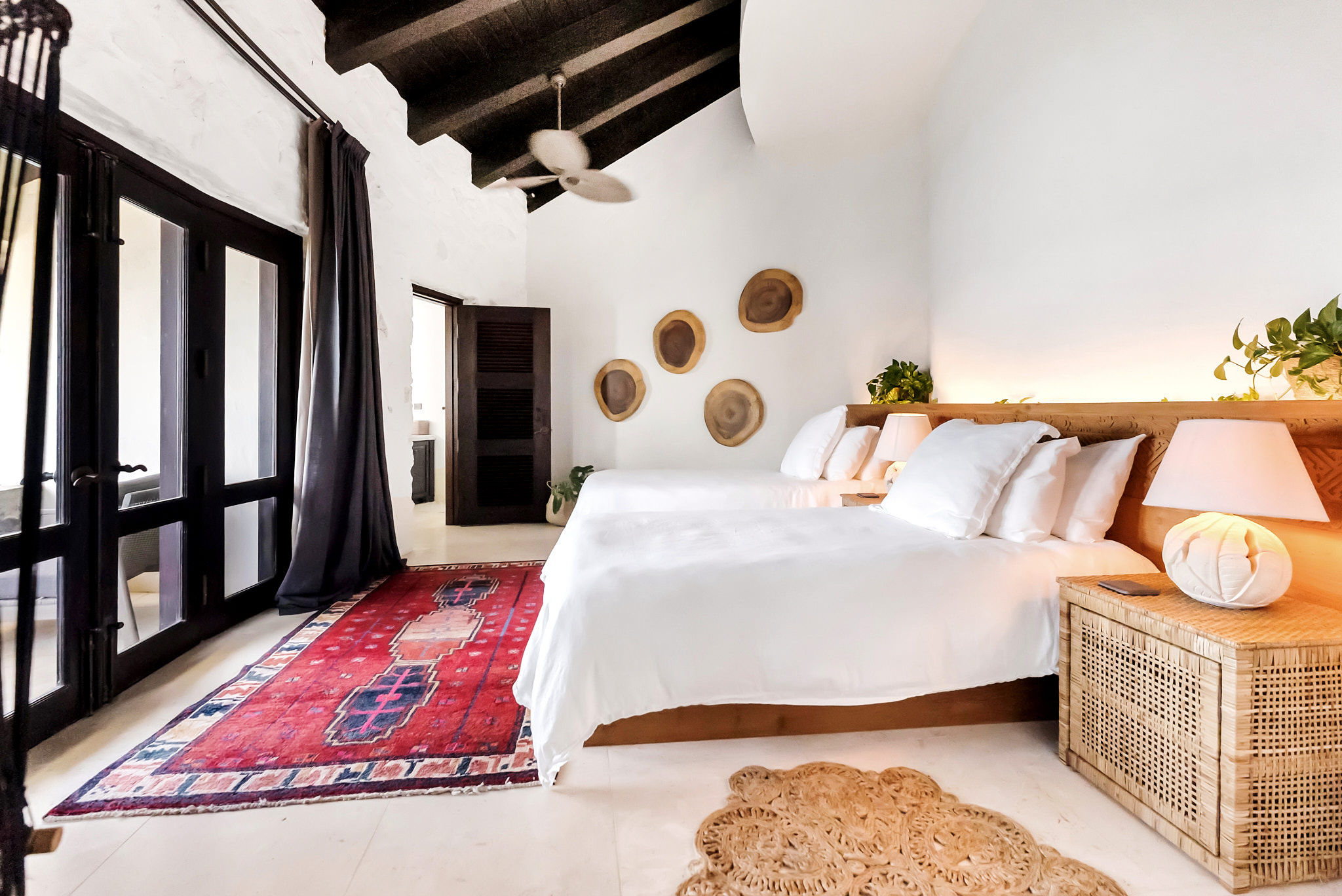 image Relax in this cheerful suite with balcony doors, pops of color, and earthy accents.