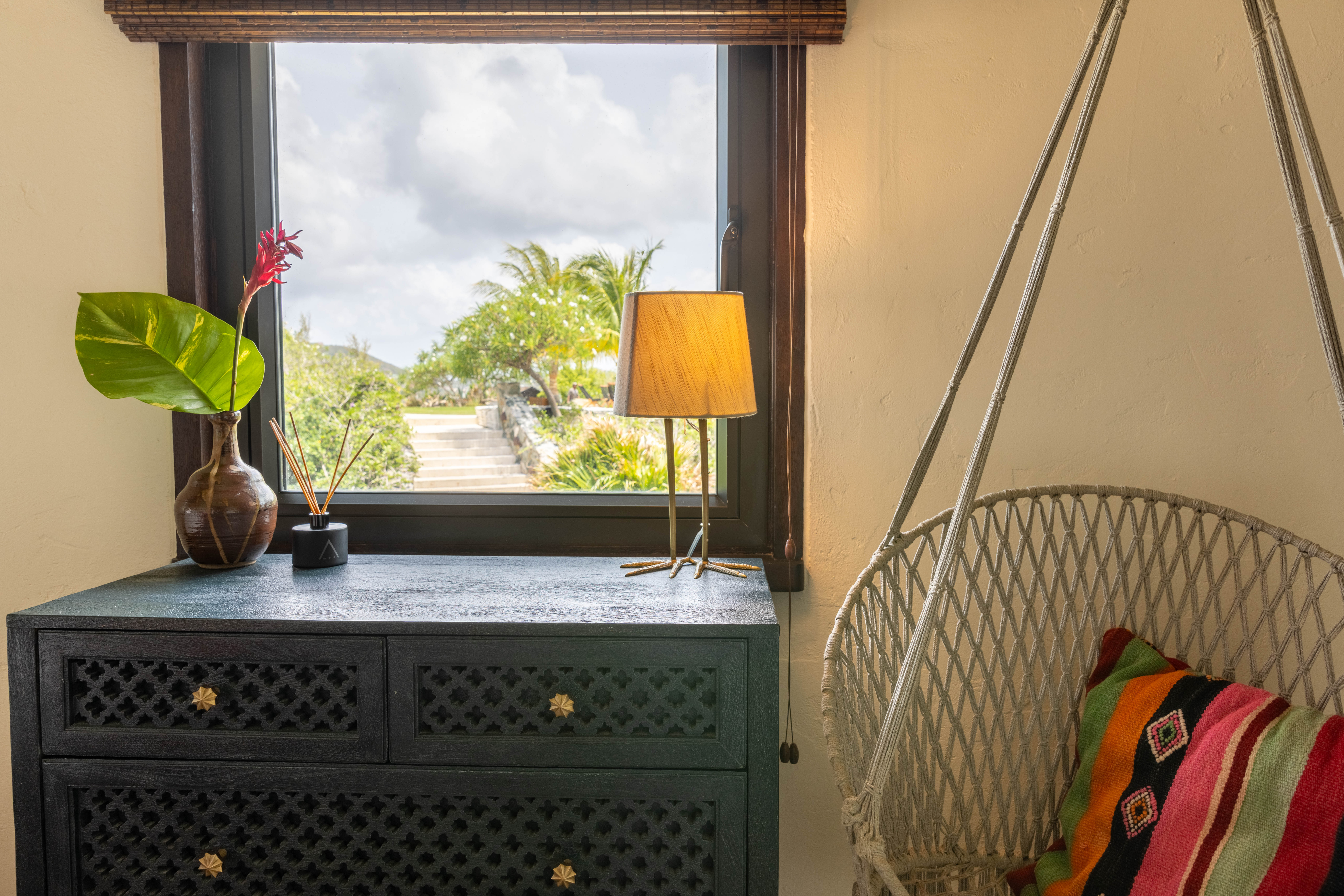 image Window seating and hanging chair create a relaxed corner with lush garden views.