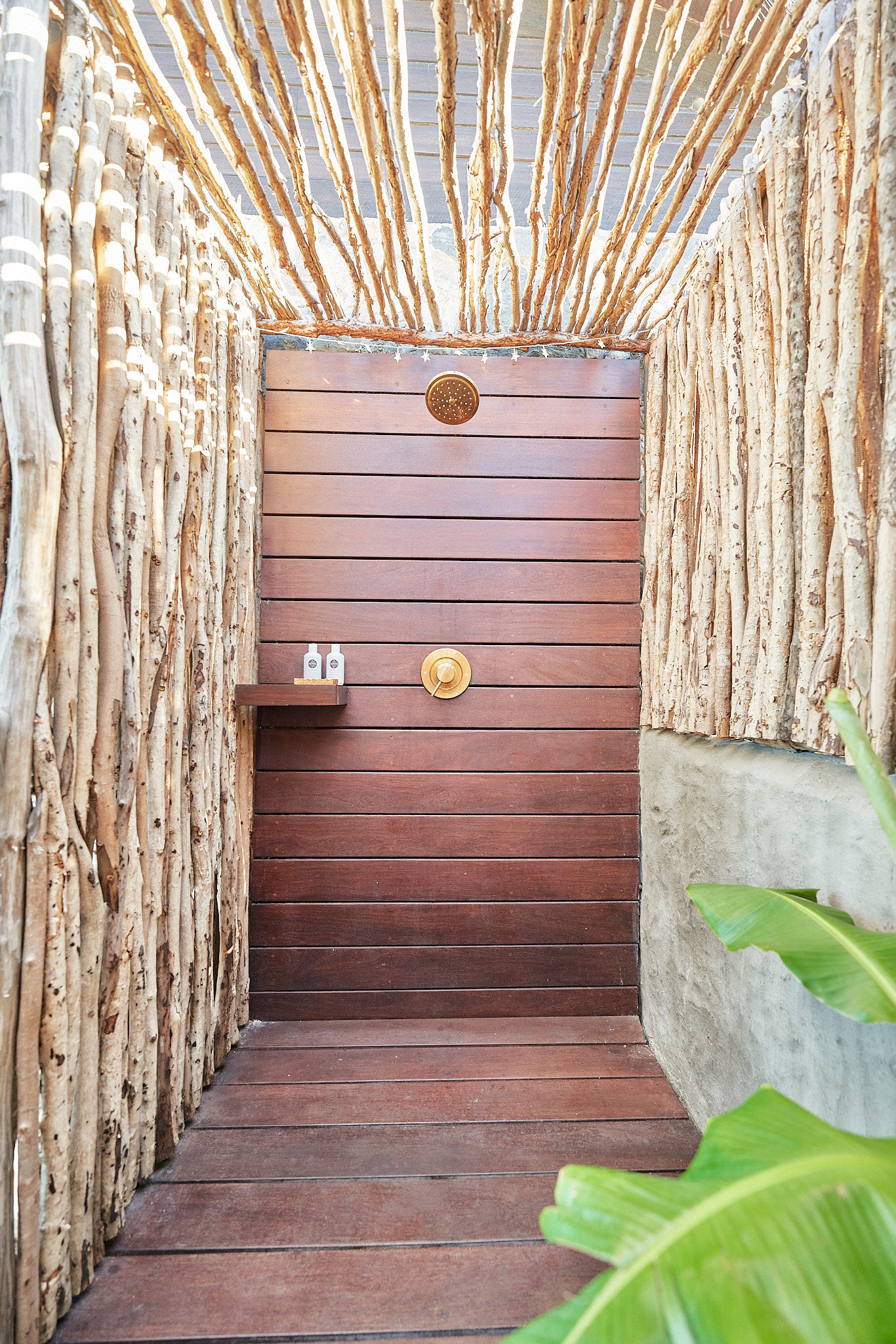 image Private outdoor shower wrapped in bamboo for a rustic island experience.
