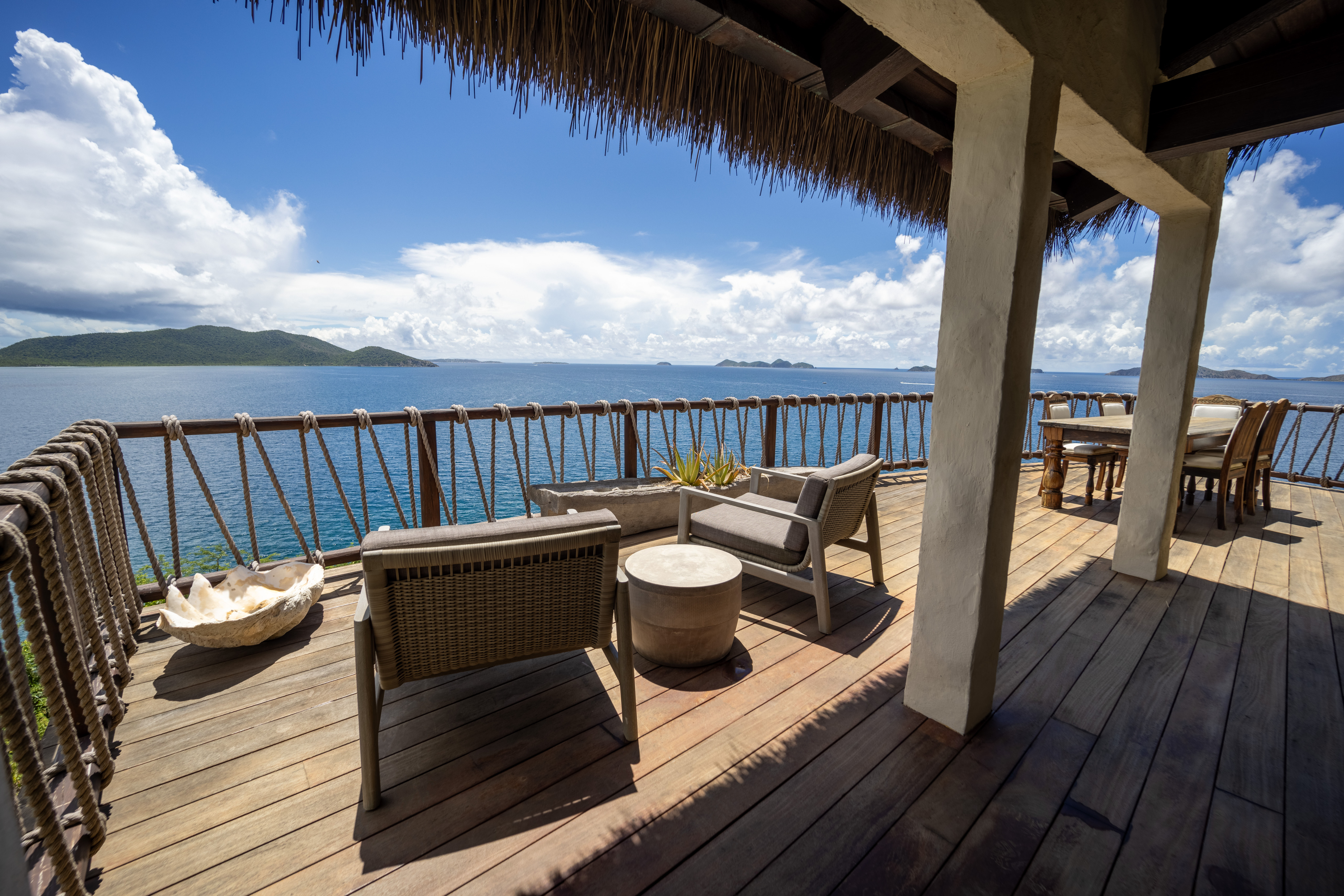 image Oceanview deck with cozy lounge chairs, shaded canopy, and panoramic Caribbean skies.