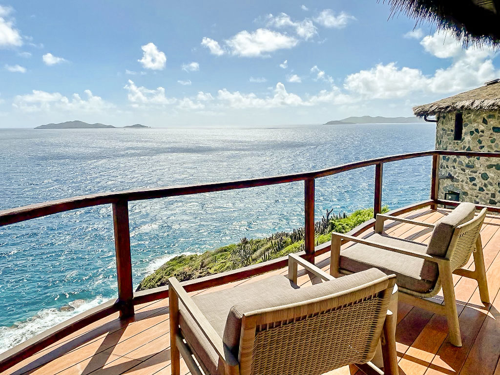 image Private terrace with inviting lounge chairs overlooking breathtaking Caribbean sea views.