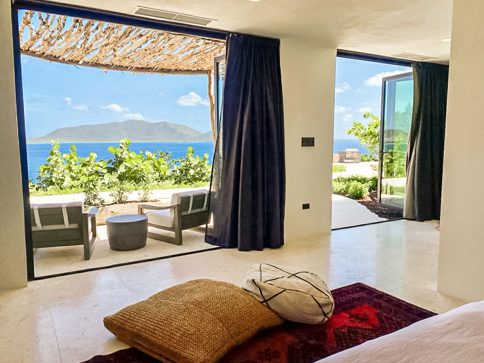 image Bright and airy indoor space with floor-to-ceiling windows showcasing the sea.