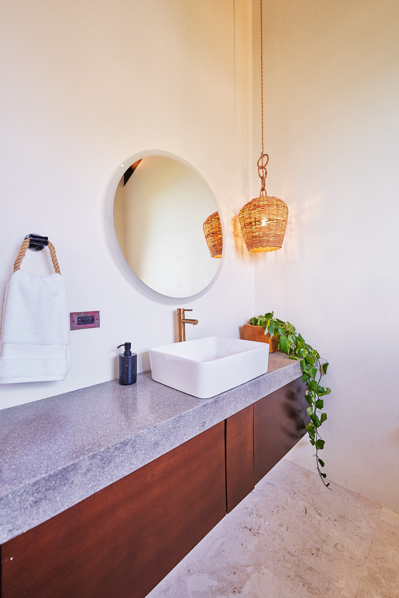 image Modern bathroom with minimalist design, vessel sink, and elegant hanging light fixture.