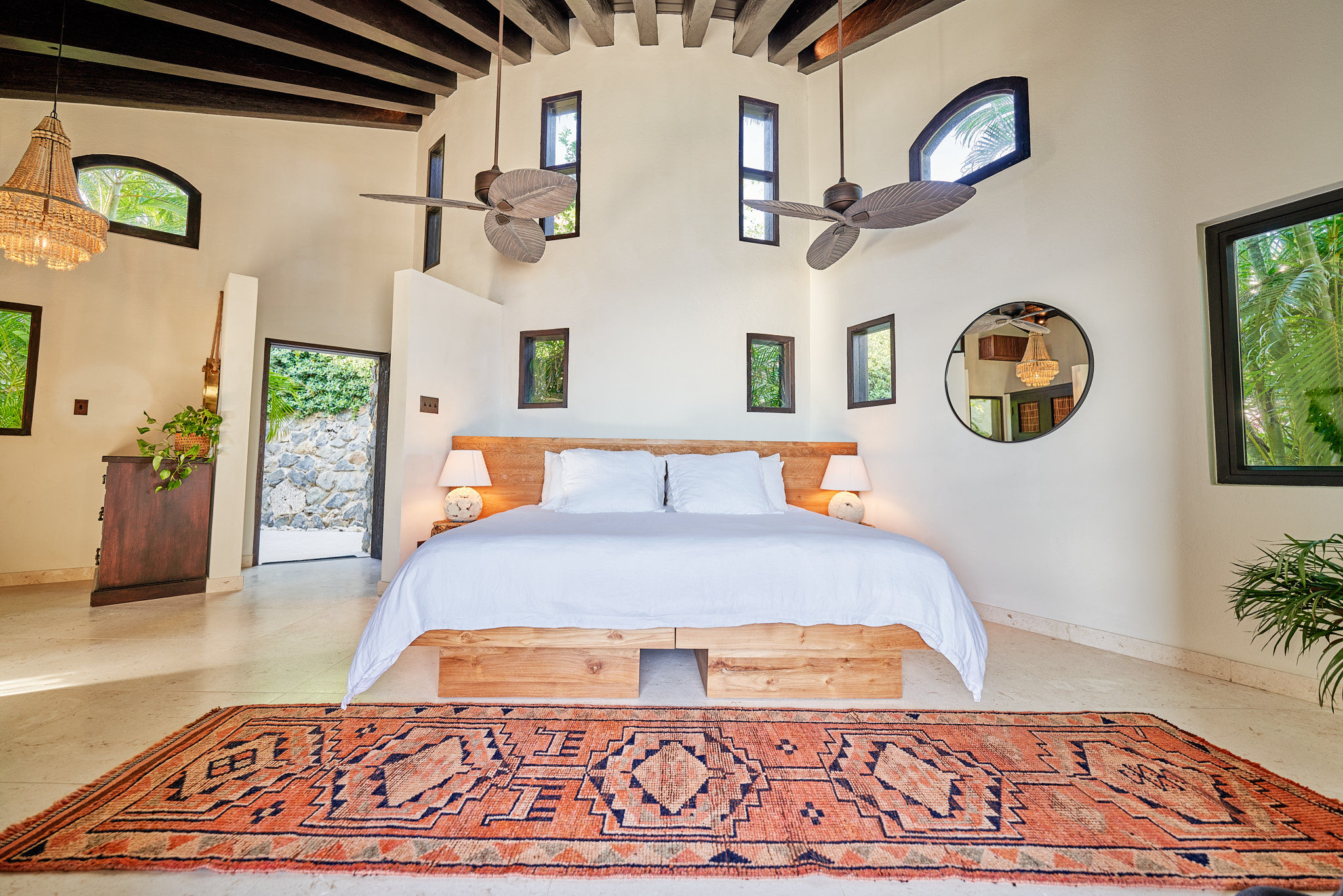 image Elegant suite with king bed, woven accents, and full wall of glass doors.