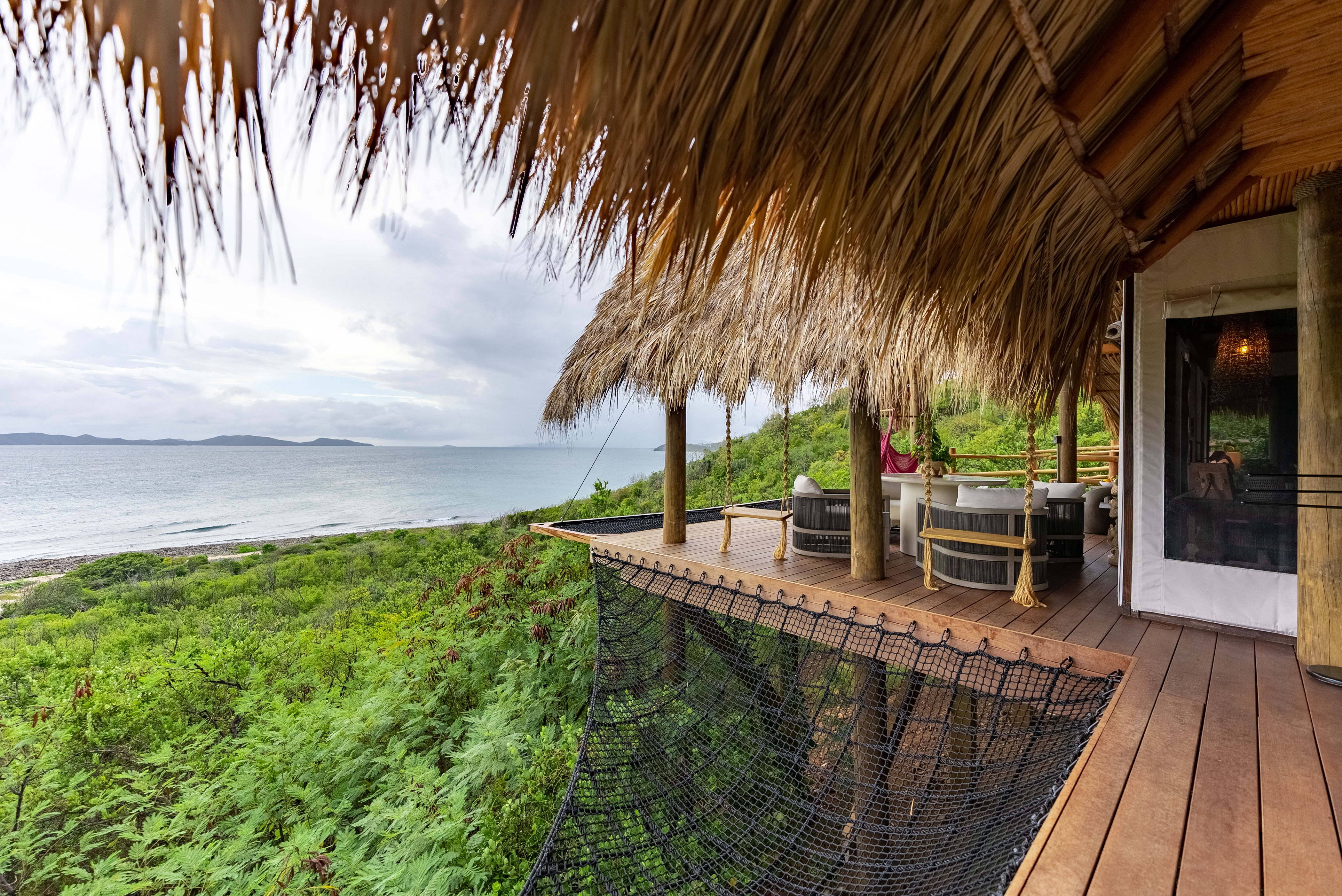 image Reconnect with nature on your expansive deck, where sweeping ocean views and cozy stargazing nets create the ultimate backdrop for unforgettable moments in paradise.